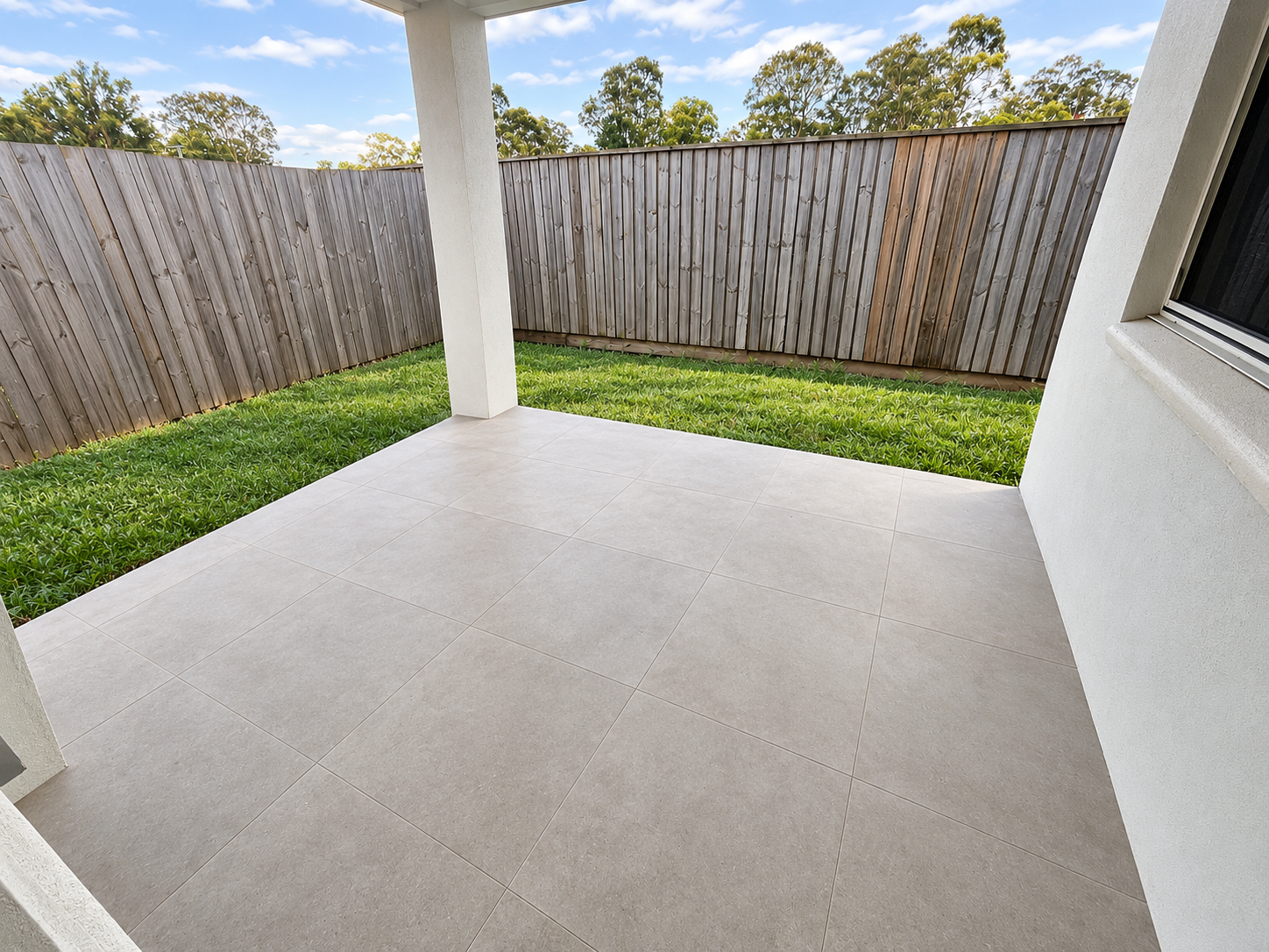 Clean Tiled Patio and Fenced Backyard.png