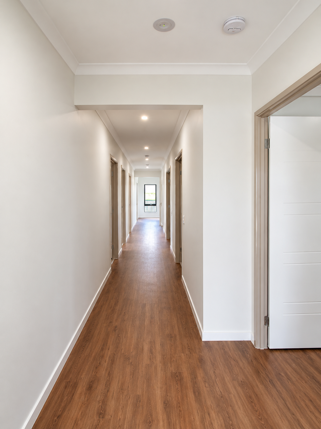 Bright Minimalist Hallway with Wood Floors.png