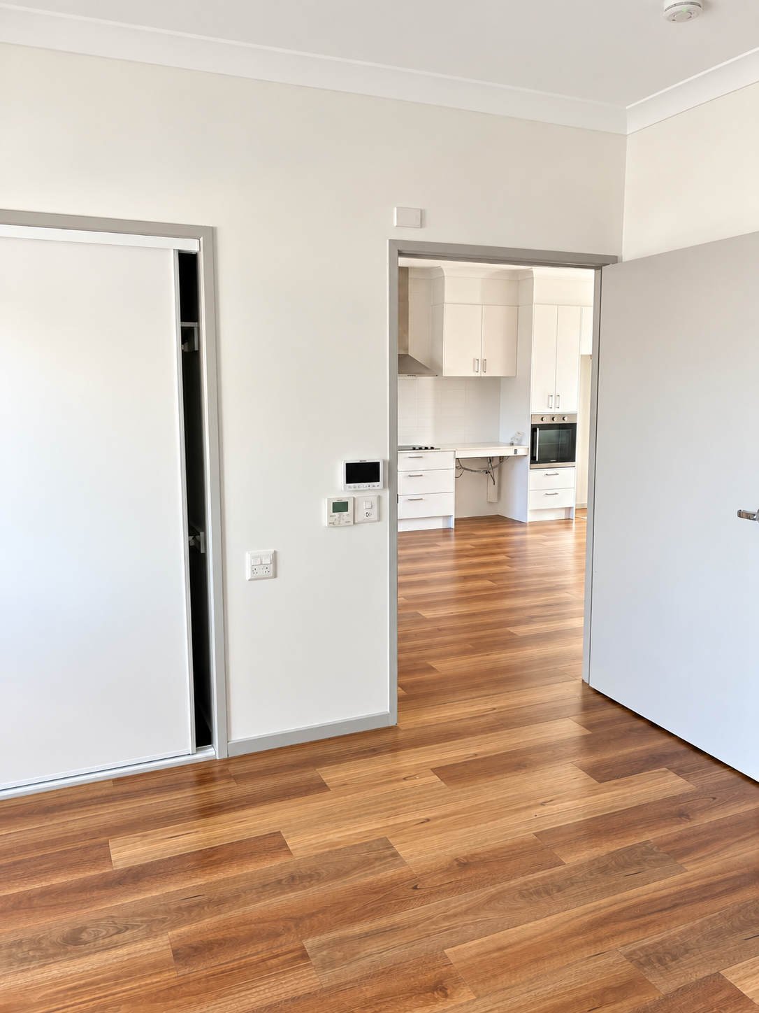 Minimal Room with Bright Kitchen View.png