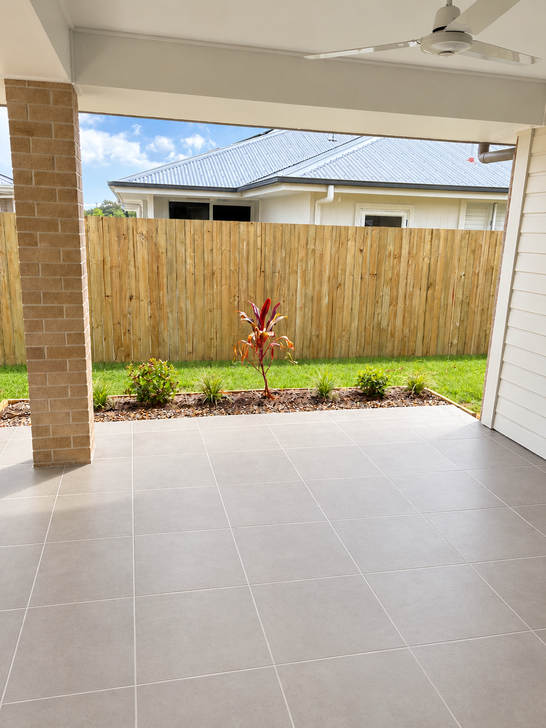 Modern Patio Overlooking Landscaped Backyard.png