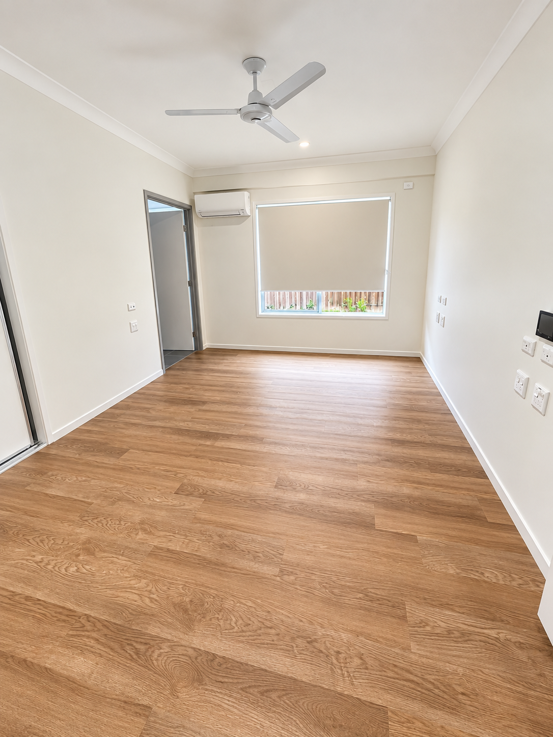 Bright Minimalist Room with Wood Flooring.png