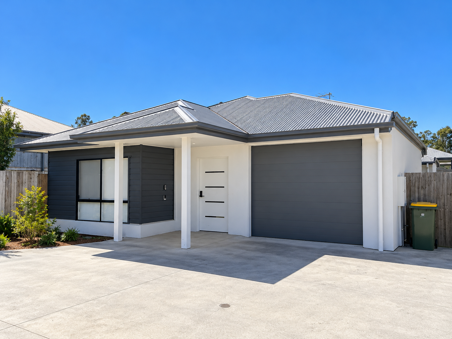 Modern Suburban House with Garage and Driveway.png