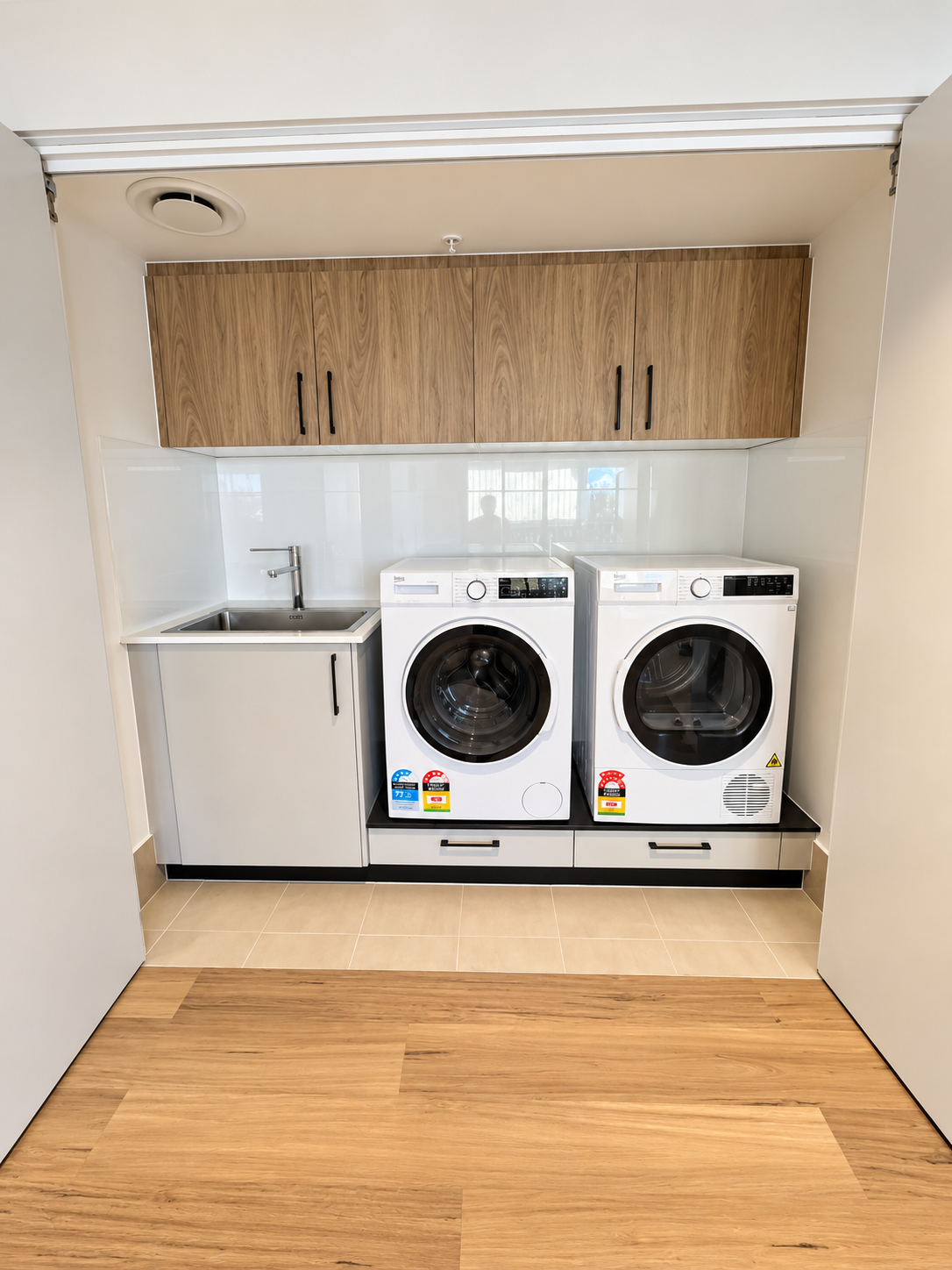 Bright Modern Laundry Nook with Wood Cabinetry.png