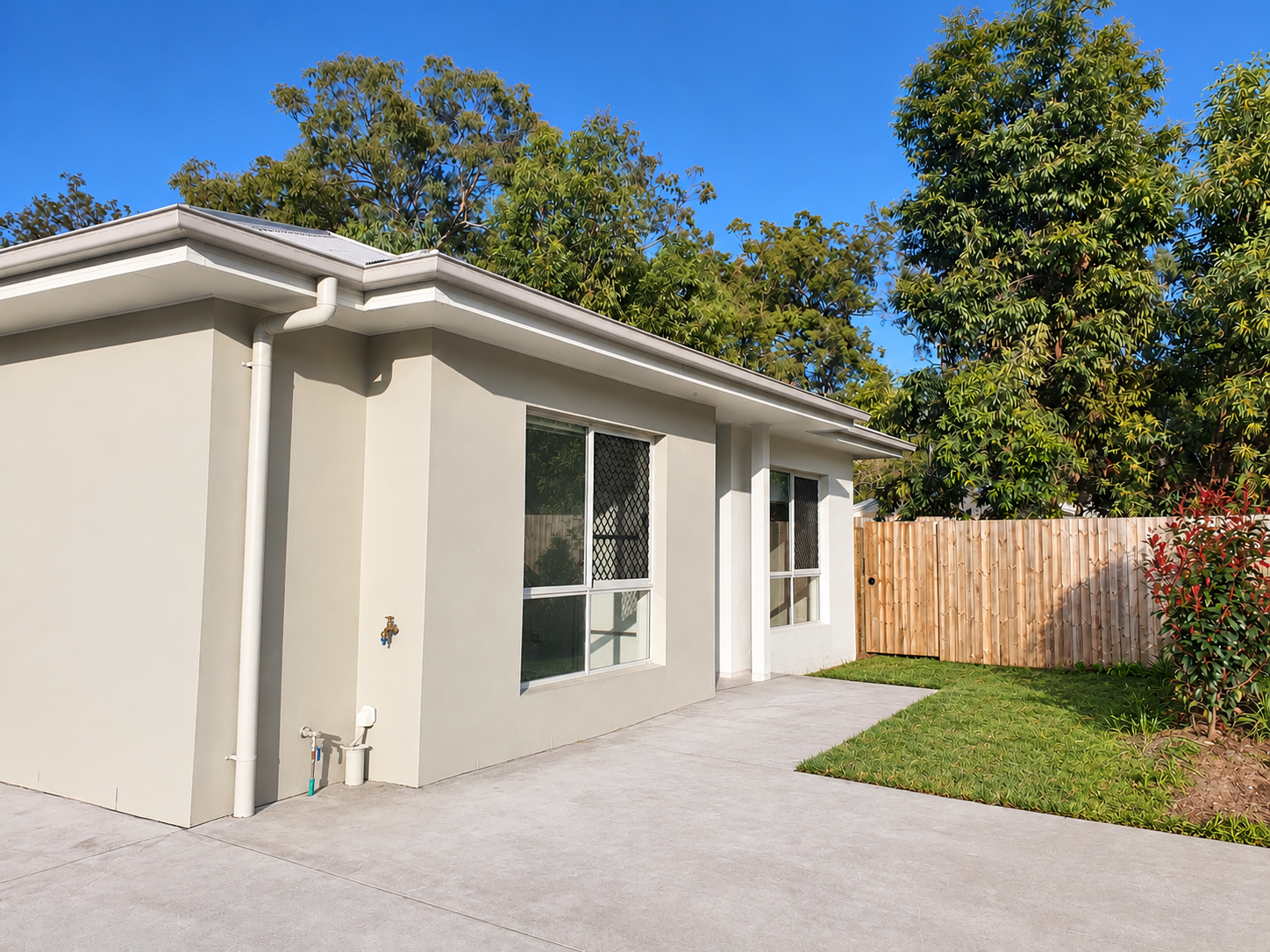 Sunlit Suburban House and Backyard Corner.png