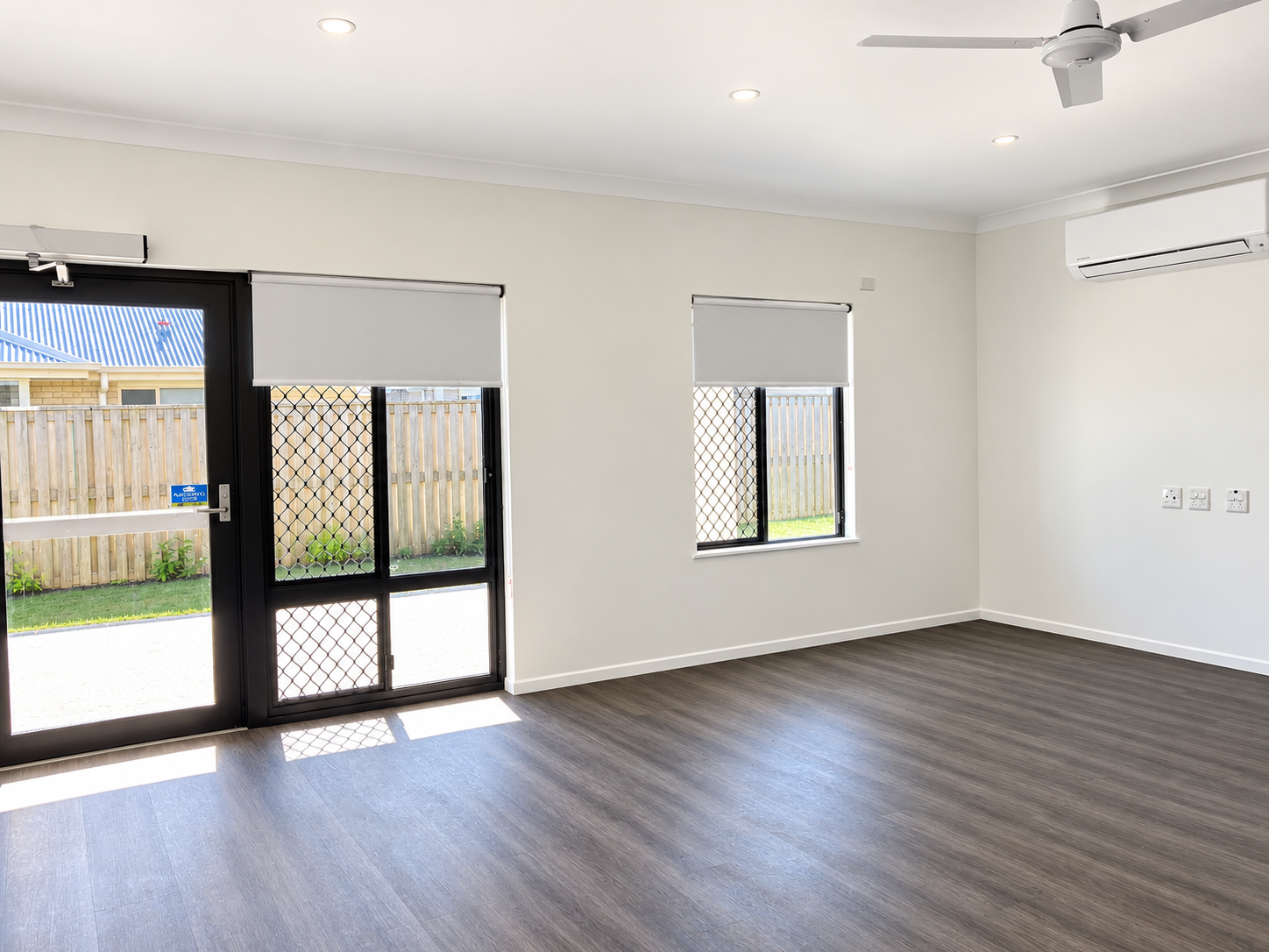 Sunlit Minimalist Room with Glass Doors.png