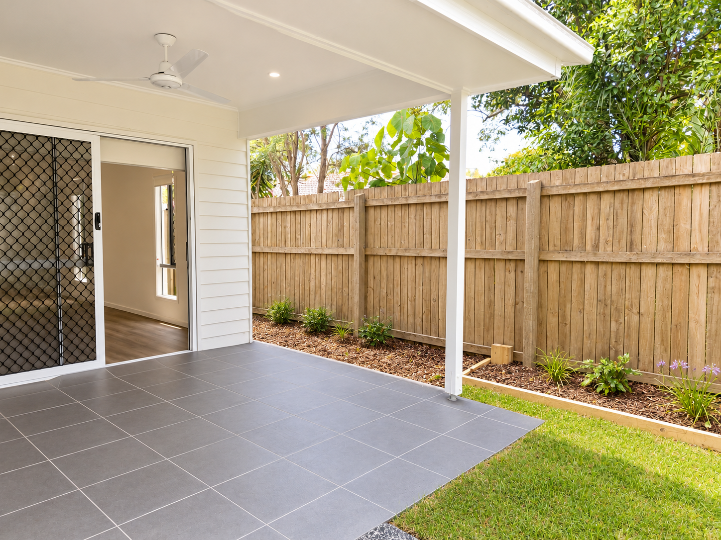 Modern Backyard Patio with Lush Garden.png