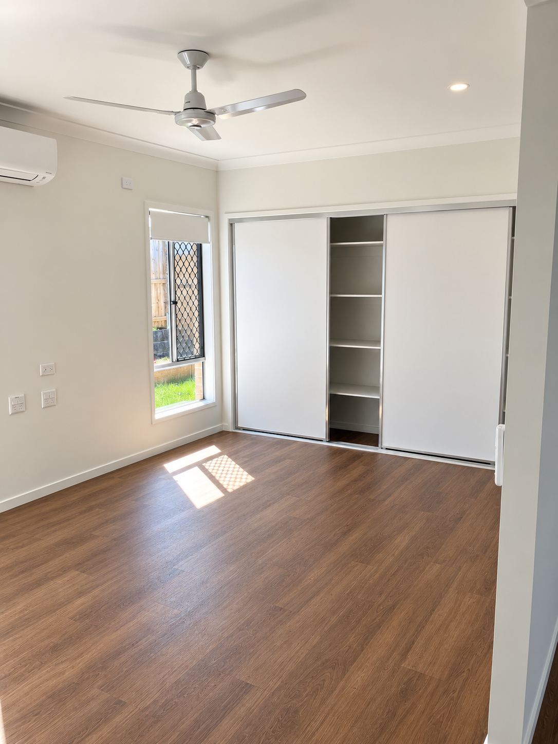 Bright Minimalist Bedroom with Built-In Wardrobe.png