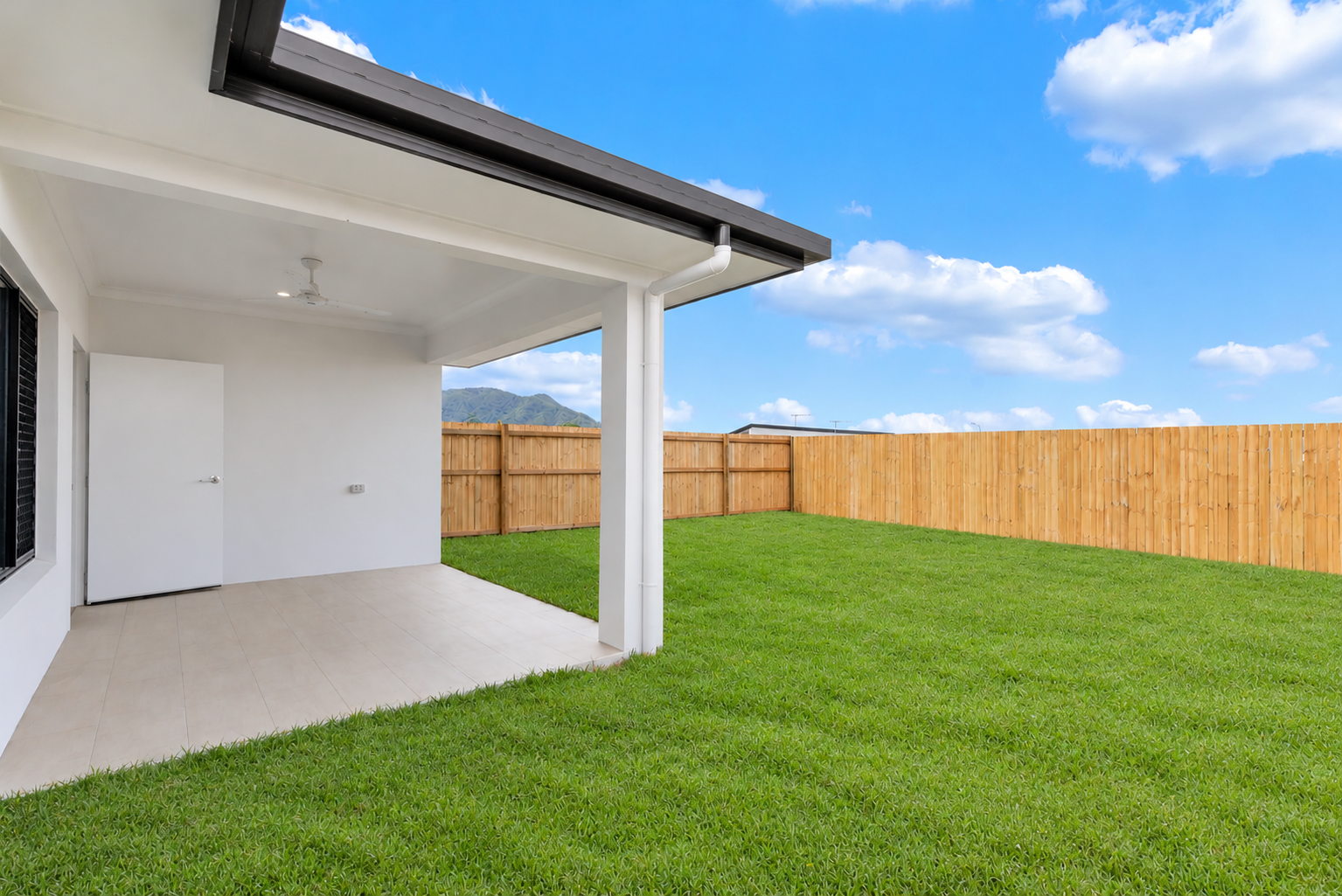 Modern Patio with Tidy Mountain-View Lawn.png