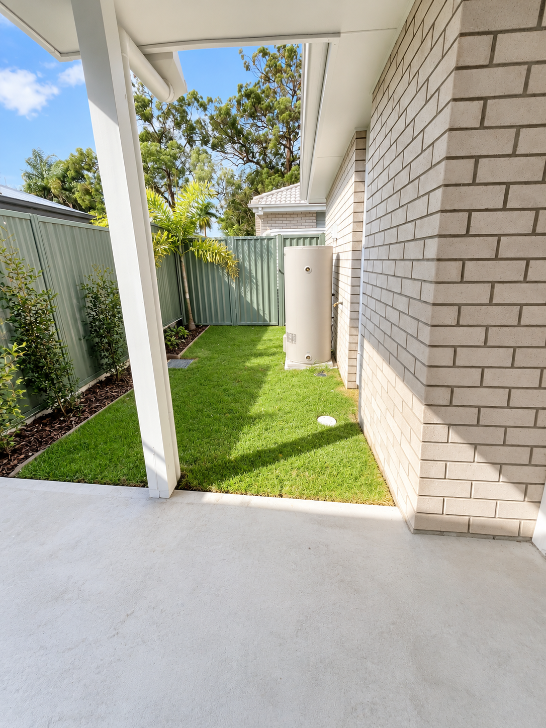 Sunny Modern Side Yard with Hot Water Tank.png