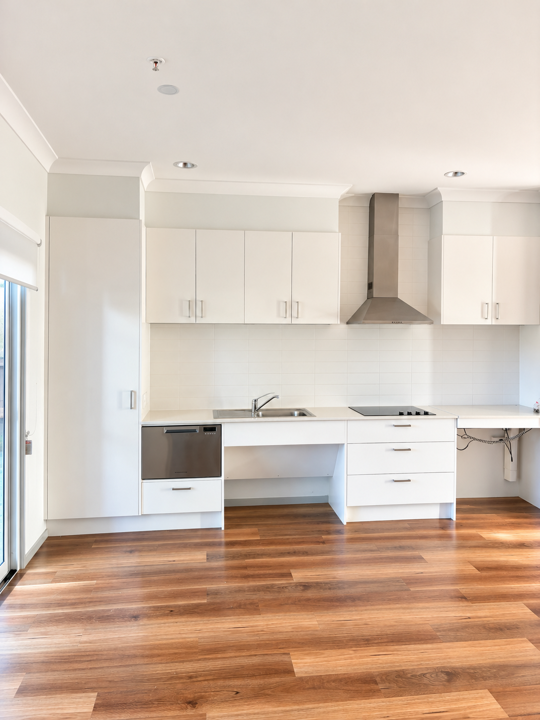 Bright Modern White Kitchen with Warm Wood Flooring.png