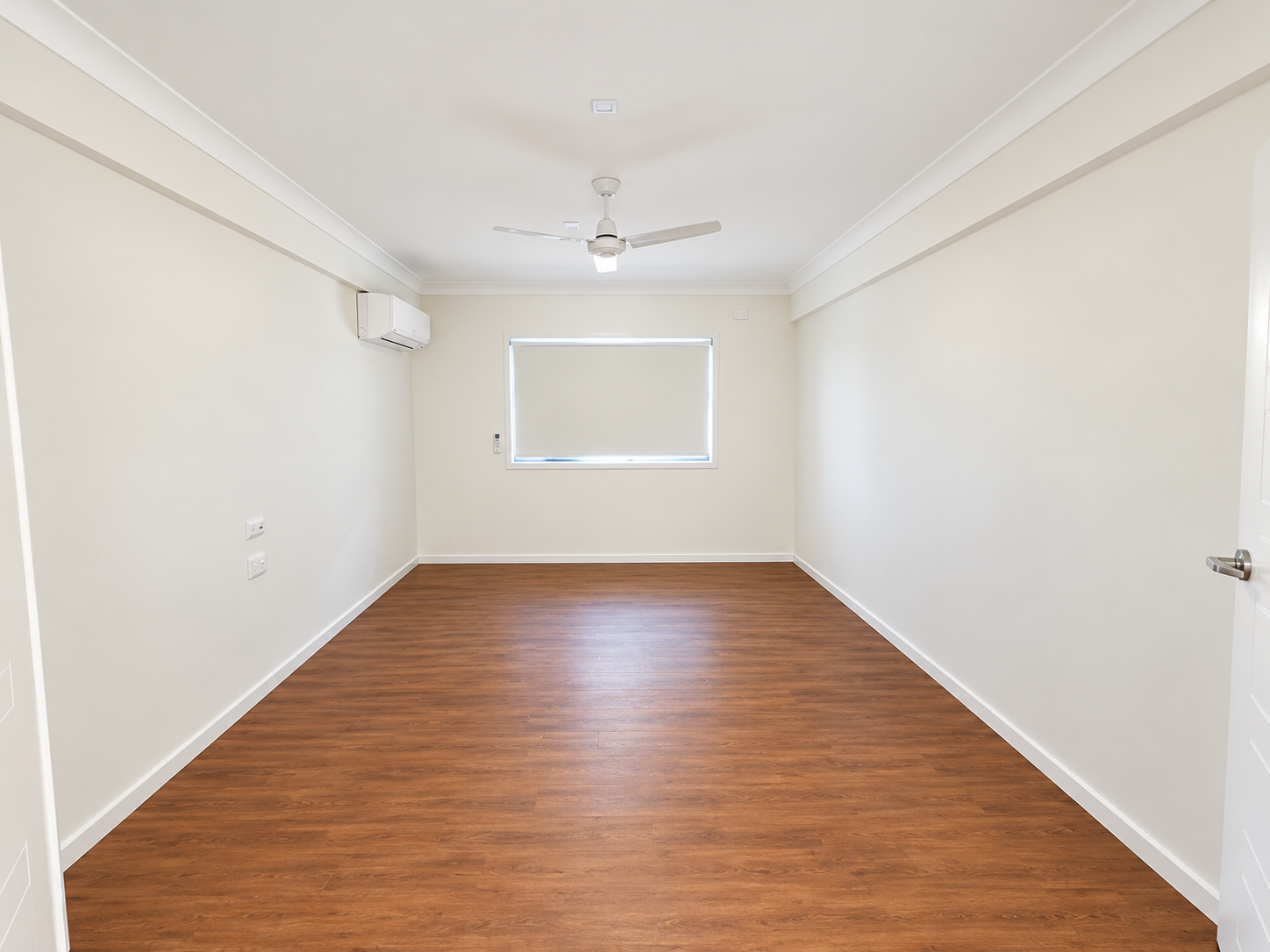 Empty Modern Room with Window and Ceiling Fan.png