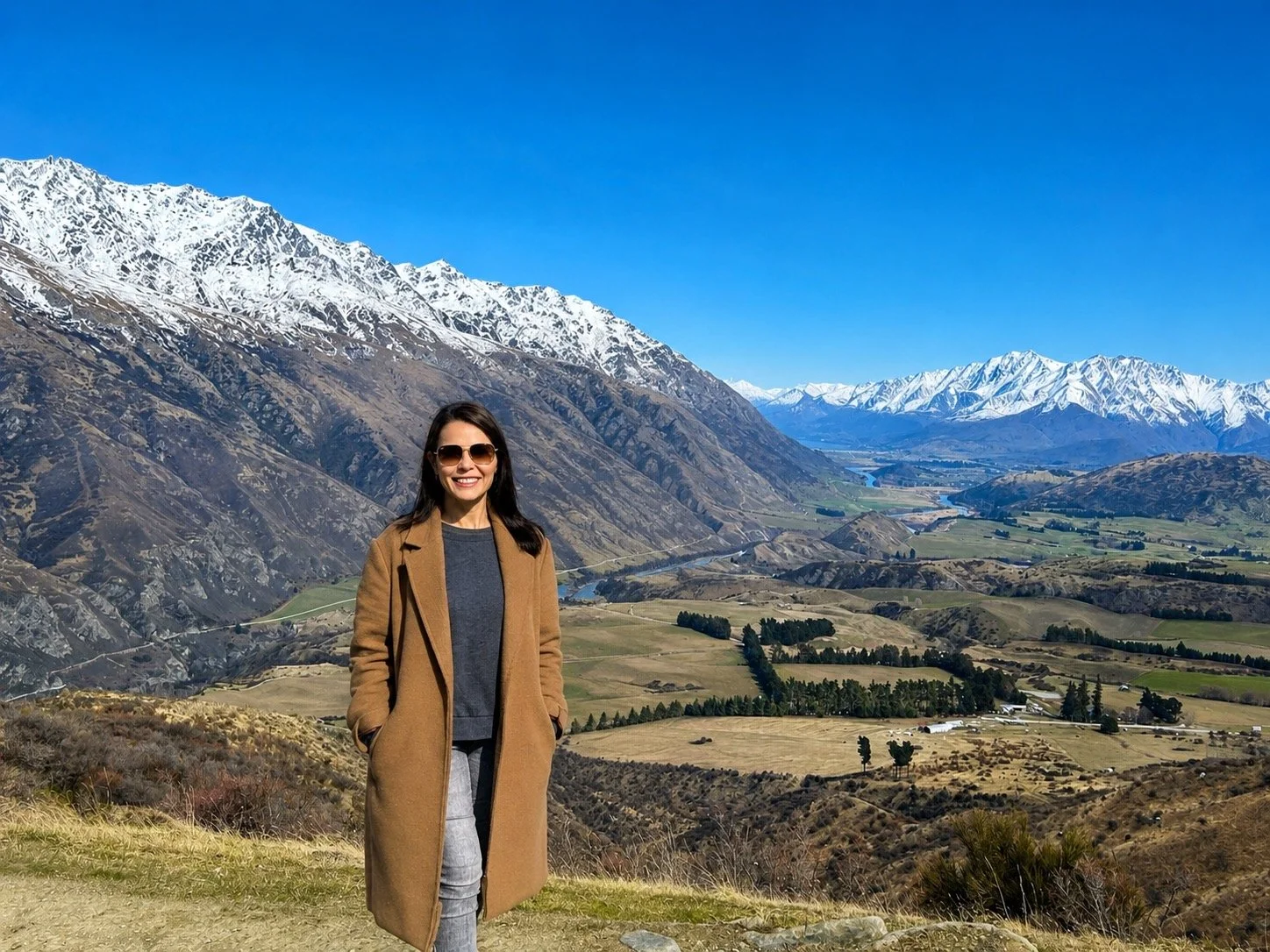 A women getting photo taken on the Crown Range while on a tour with Remarkable Scenic Tours