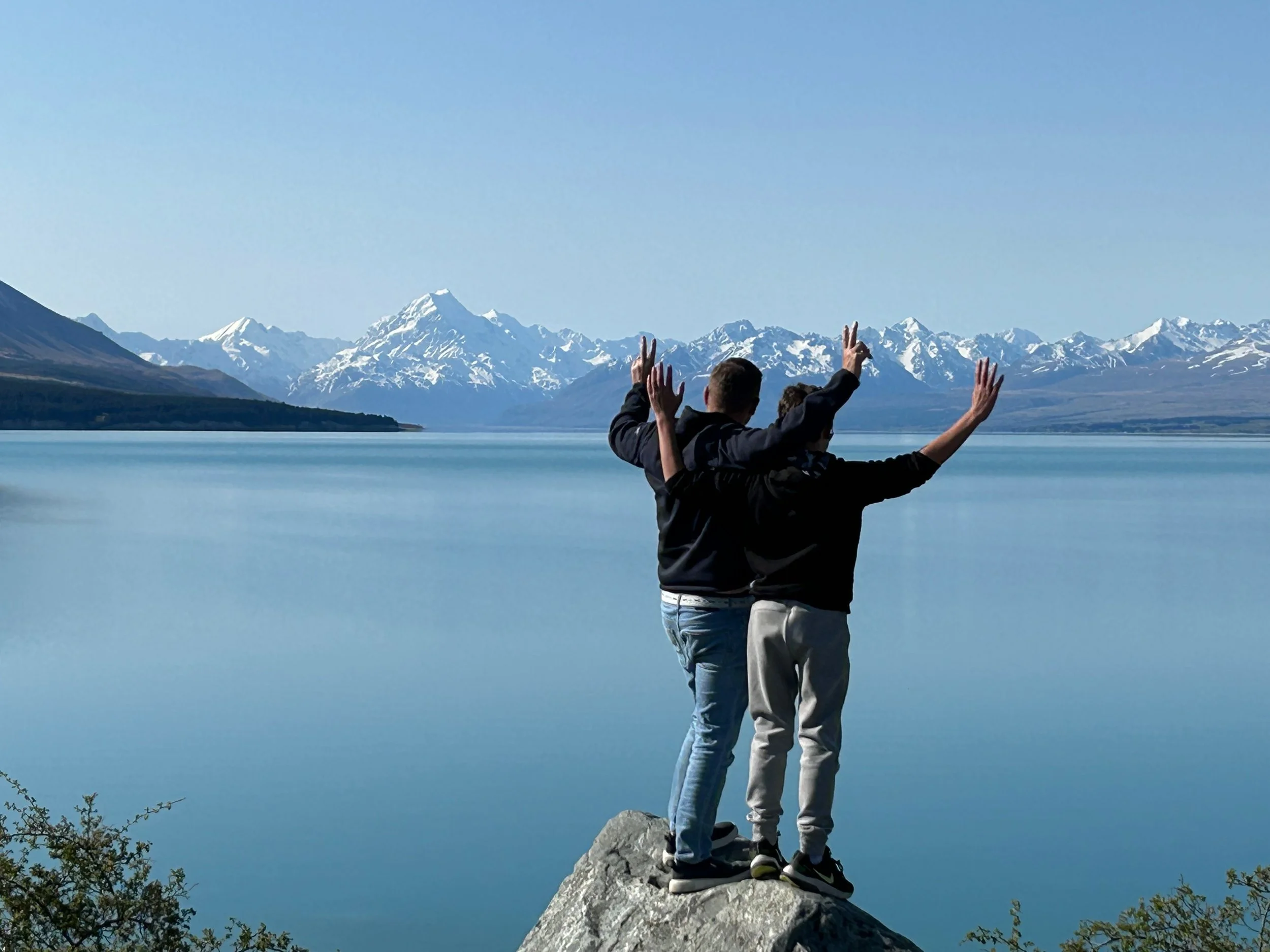 Private tour guests enjoying views across Lake Pūkaki towards Aoraki Mount Cook