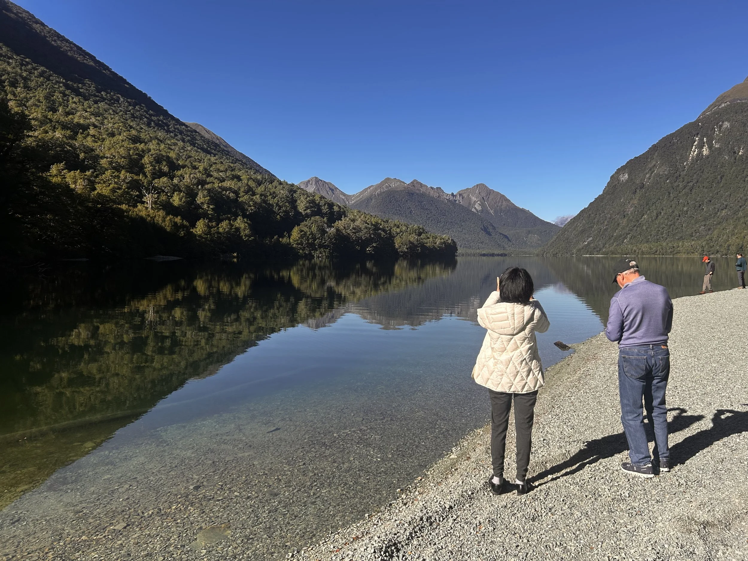 People standing by Lake Gunn.