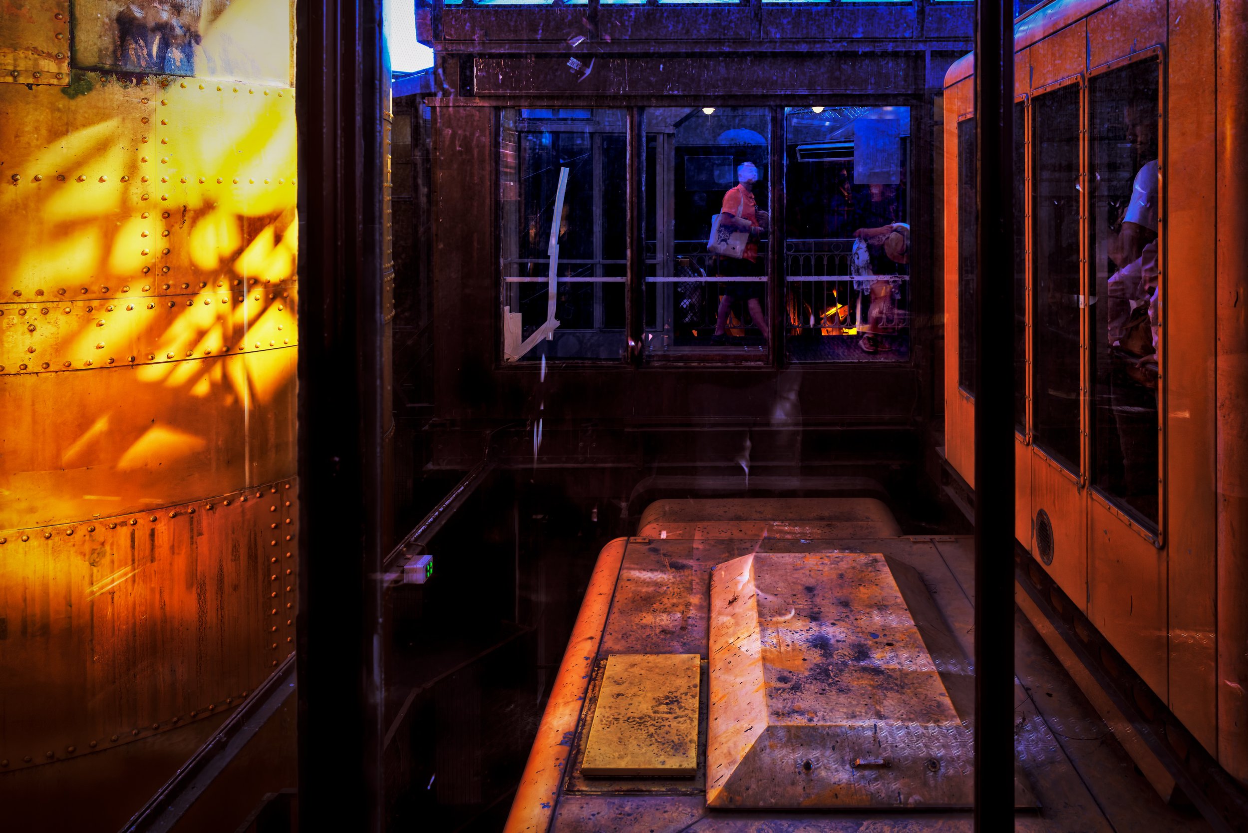 Chambers of Light

Inside the Eiffel Tower, riveted metal, elevator cars, glass, and reflected light divide the structure into a series of visual chambers. Amber surfaces glow against deep cobalt and violet, while small human figures move through the