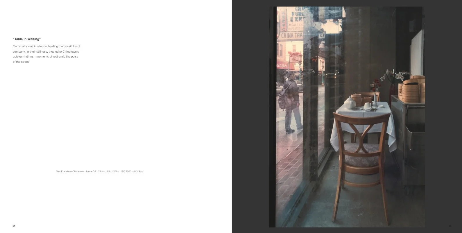 Interior spread from Concrete Lotus: Chinatown Streets titled Table in Waiting, showing an empty restaurant table and chair beside a window, with Chinatown street reflections and a pedestrian outside.