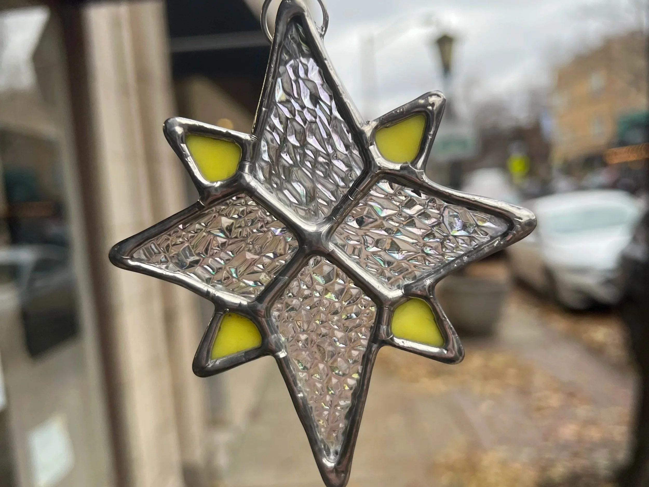 stained glass sun catchers and stained glass ornament of a jewish star and a north star both made during a glass in a flash stained glass workshop at stern glass works. these are showing diy art glass projects you can make at sgw in Oak Park IL