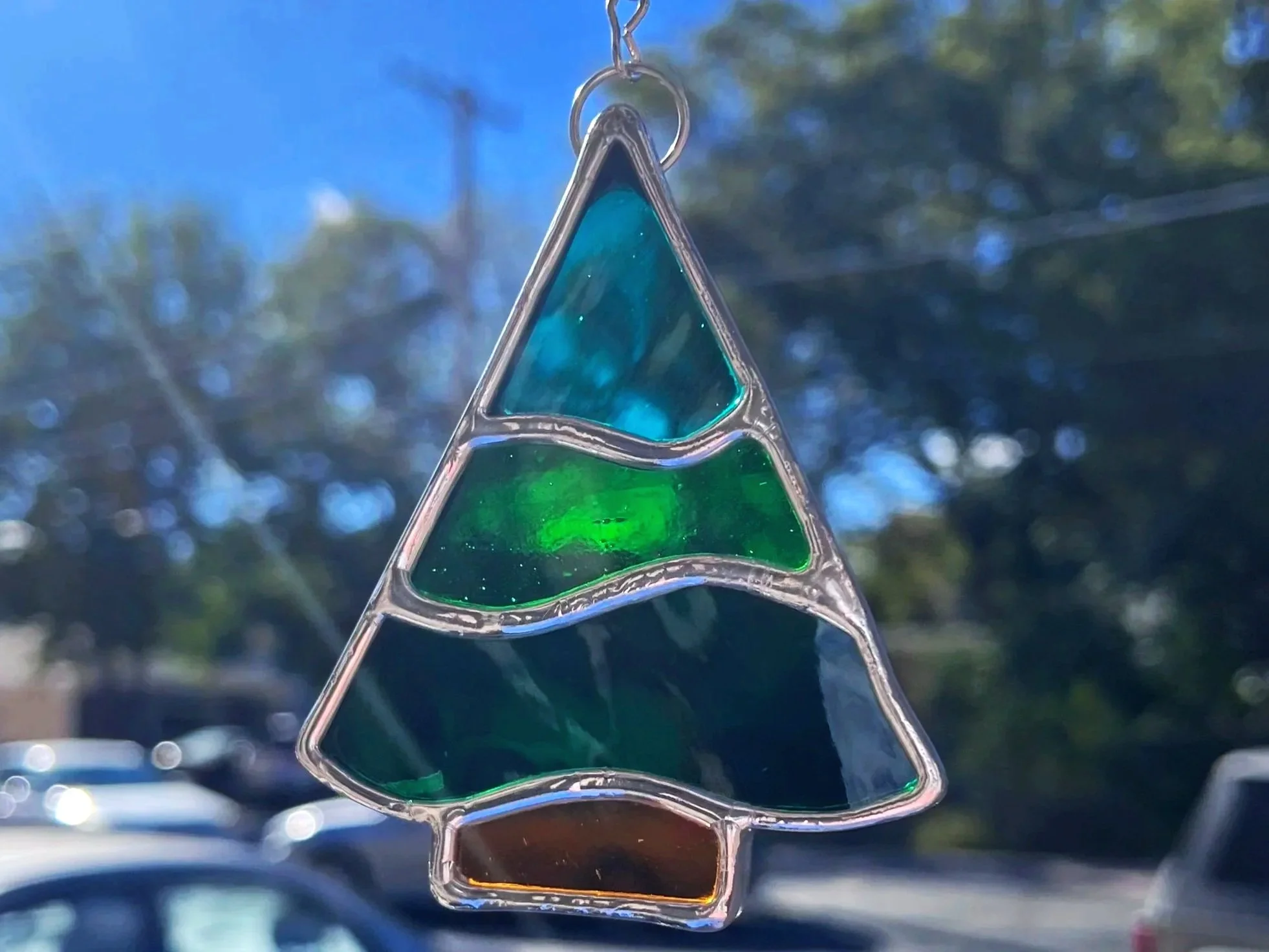 stained glass pine tree sun catcher/ ornament made in Stern Glass Works DIY workshop Glass in a Flash. the pine tree is made using the copper foil stained glass technique in oak park il outside of chicago illinois. this art glass is perfect gift