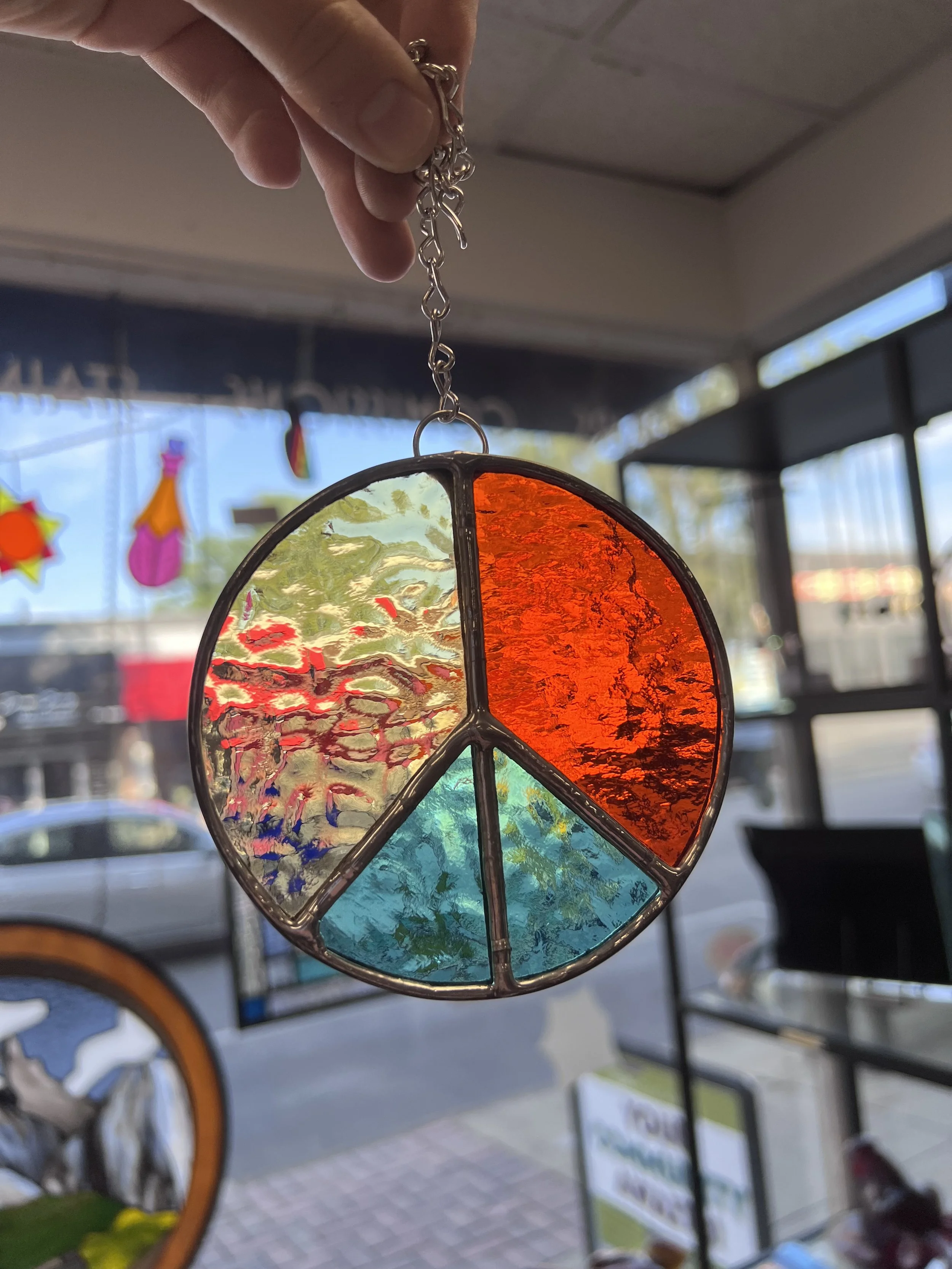 Stained glass copper foil and solder peace sign in Oak Park introductory glass in a flash class for beginners