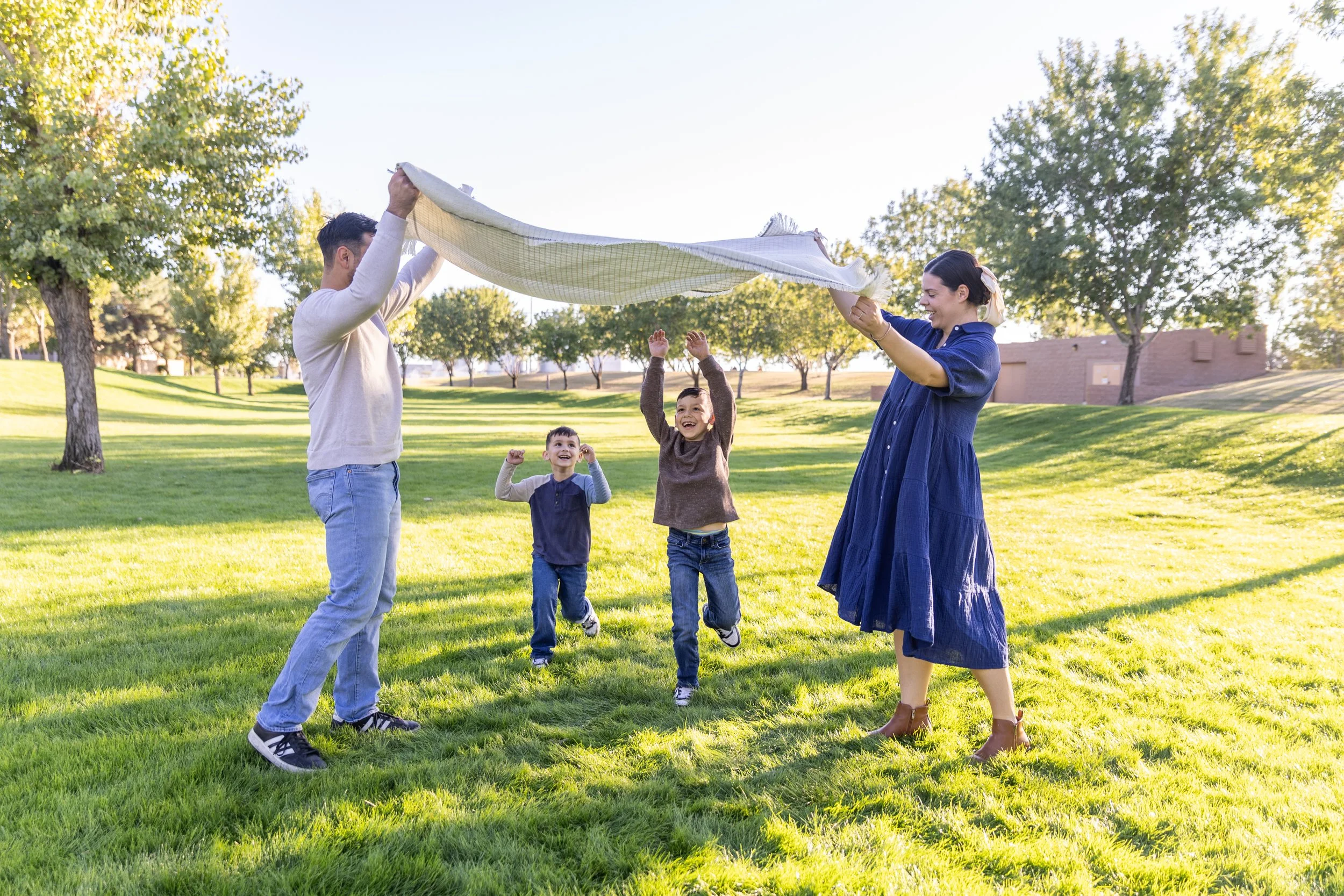 Family playing with a blanket during their ashley rose media photo session