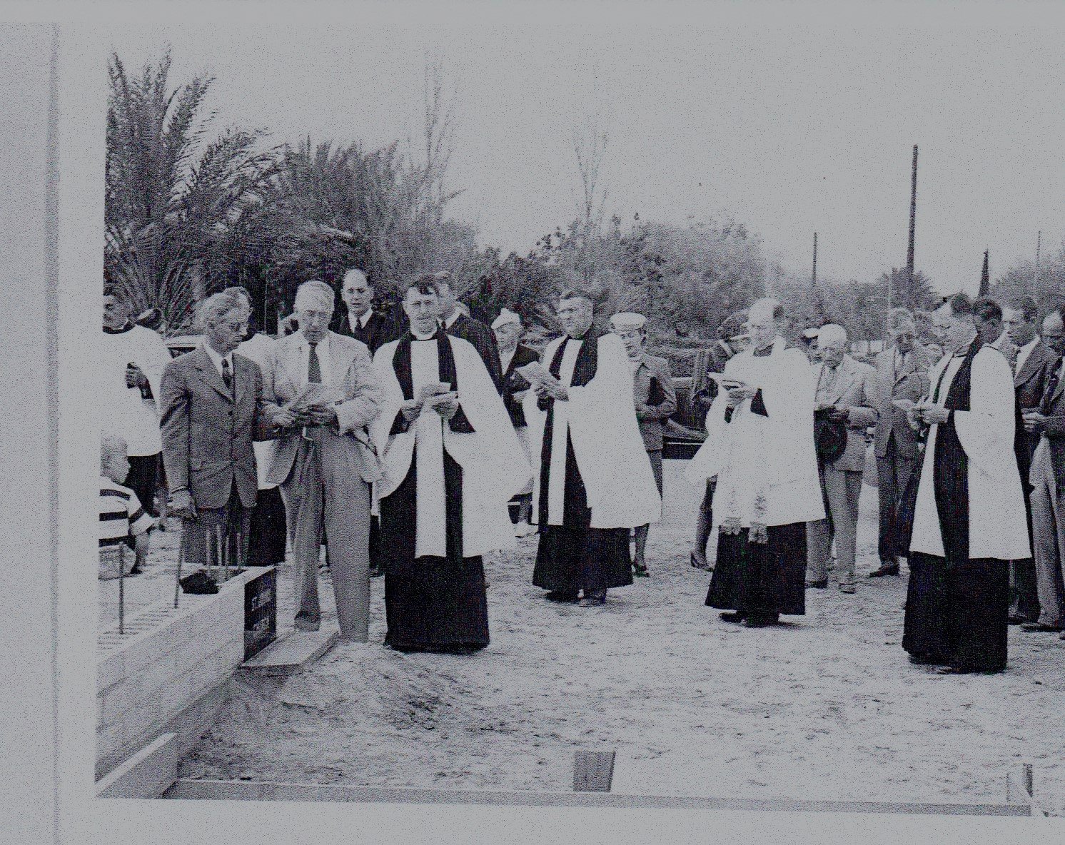Father Cander, M. Tyler and Mr. Woods lay the cornerstone.