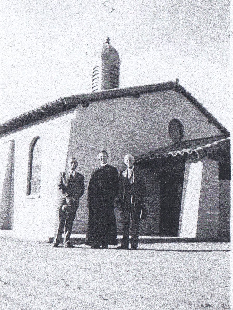 Members join Father Cander for the dedication.