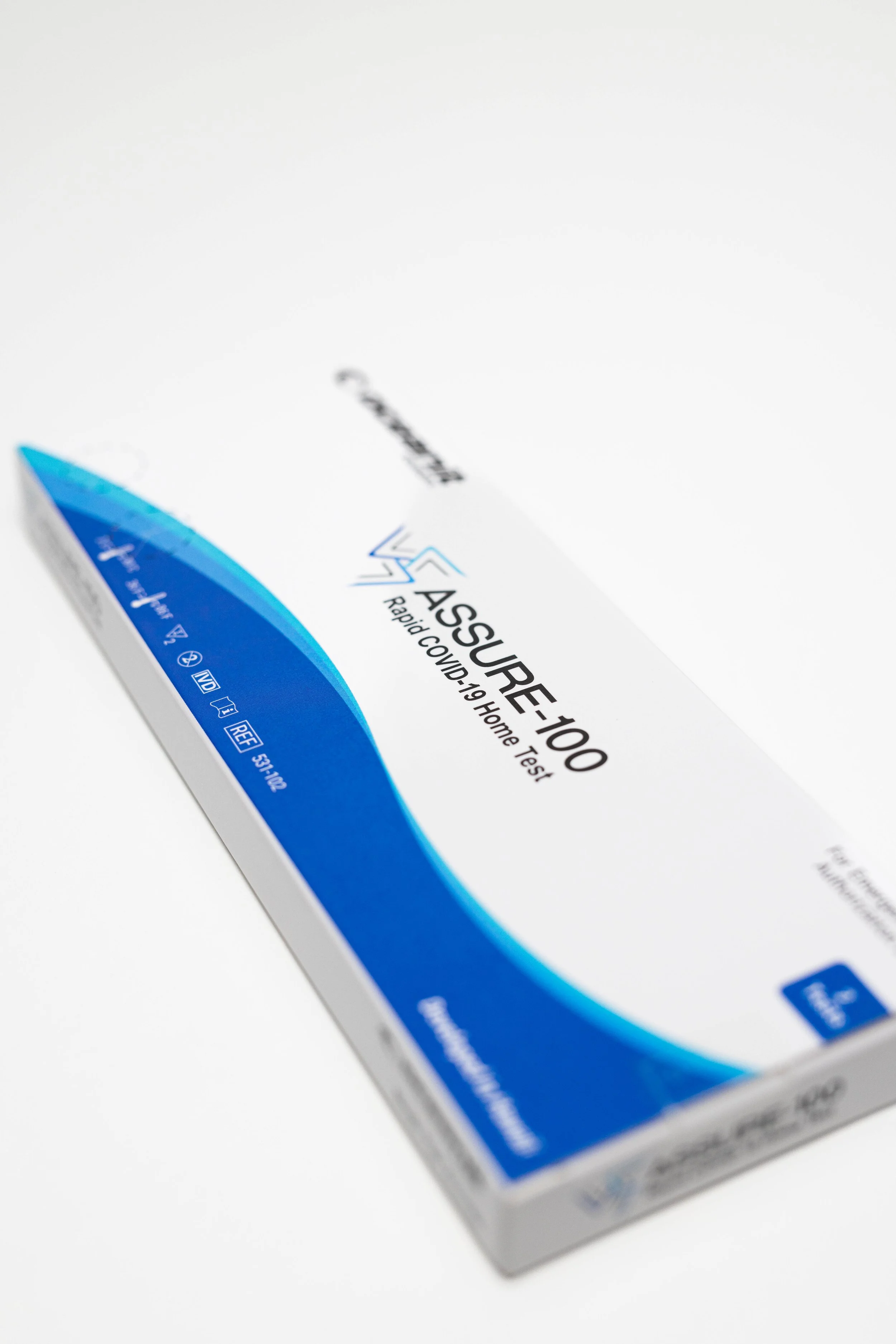 Box of Rapid COVID-19 home test kits with blue and white packaging.
