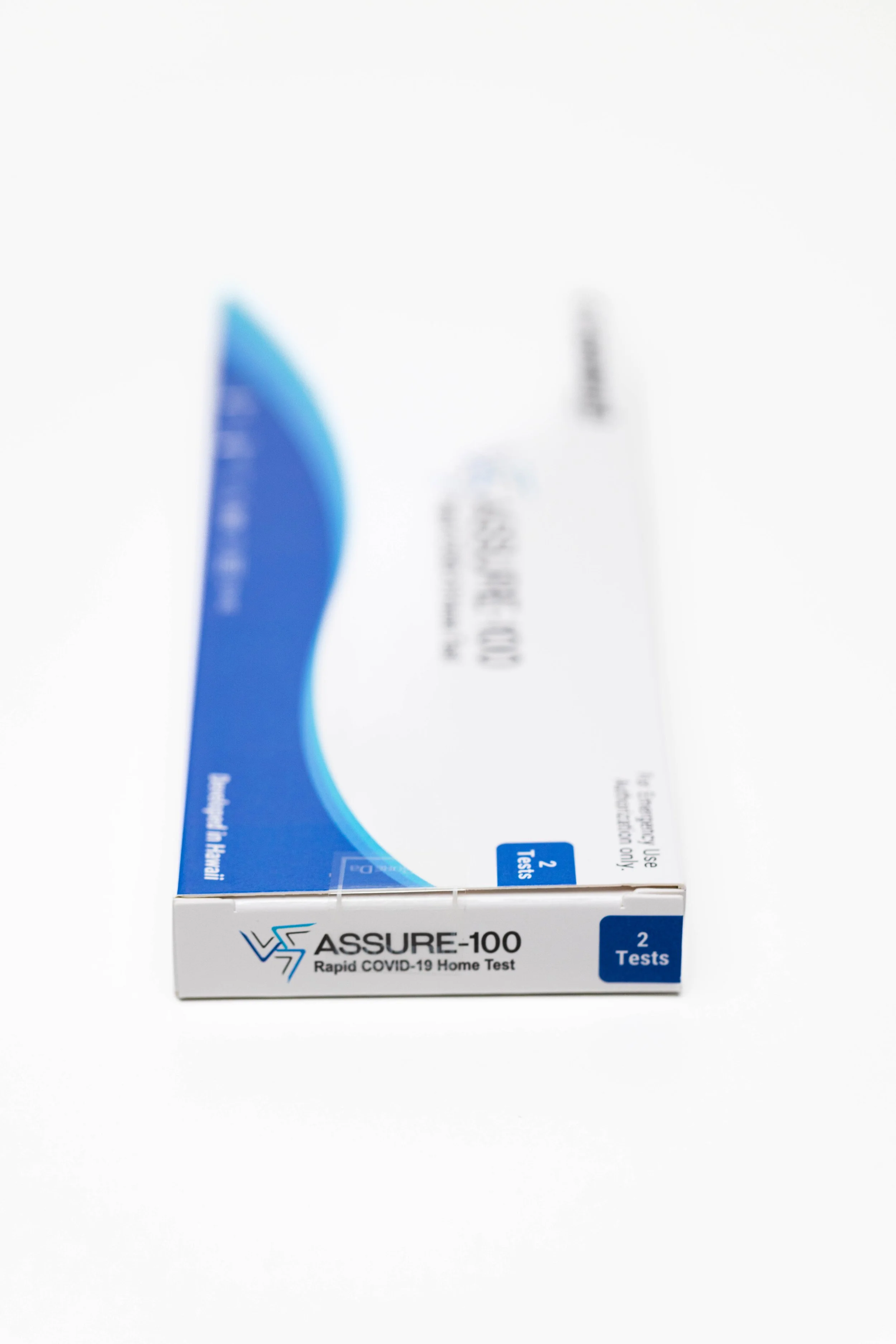 A box of ASSURE-100 Rapid COVID-19 Home Test with blue and white packaging, indicating it contains 2 tests.
