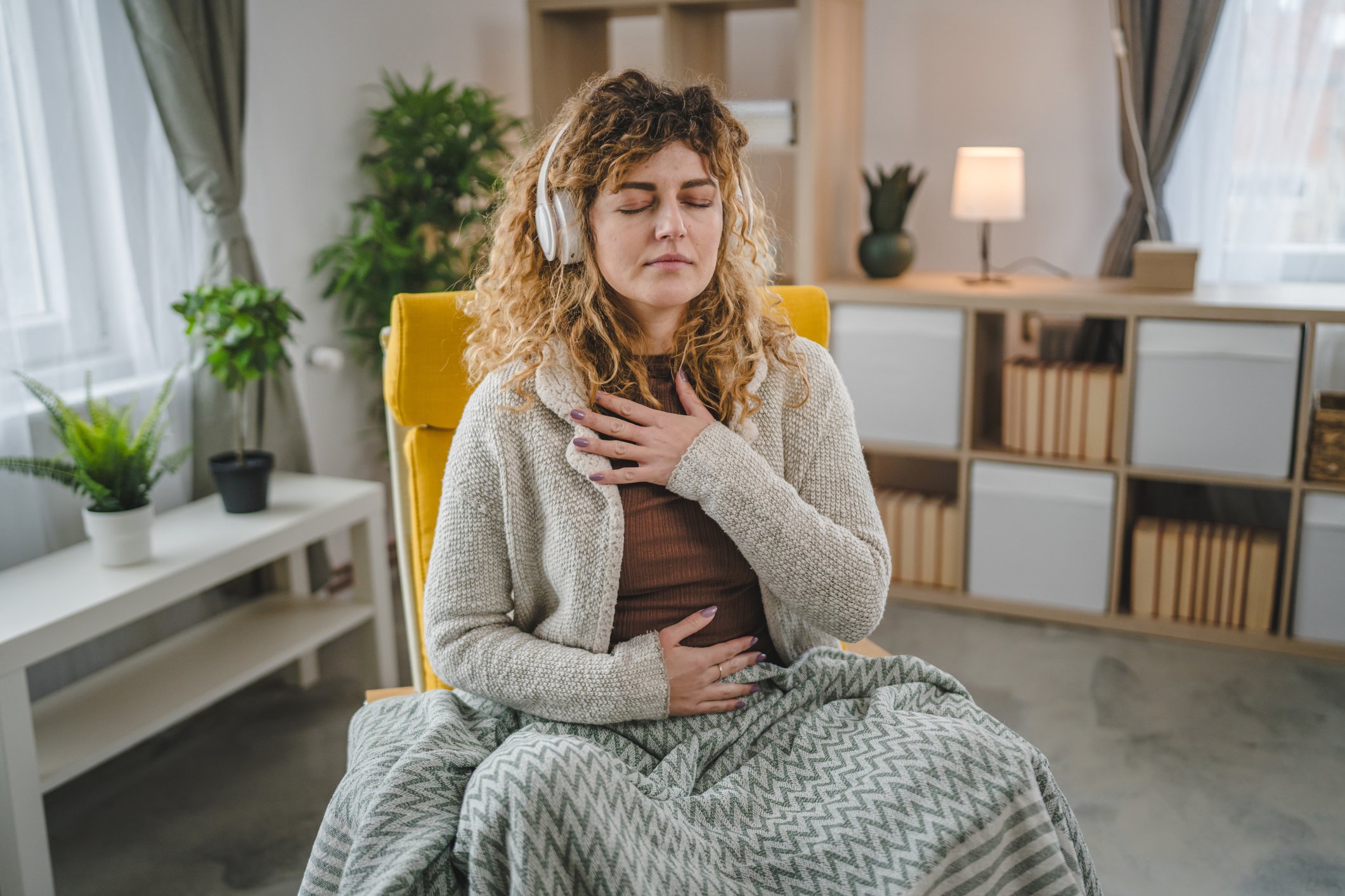 Man listening to Safe and Sound Protocol during a somatic therapy session, feeling the relaxing effects of the music. 