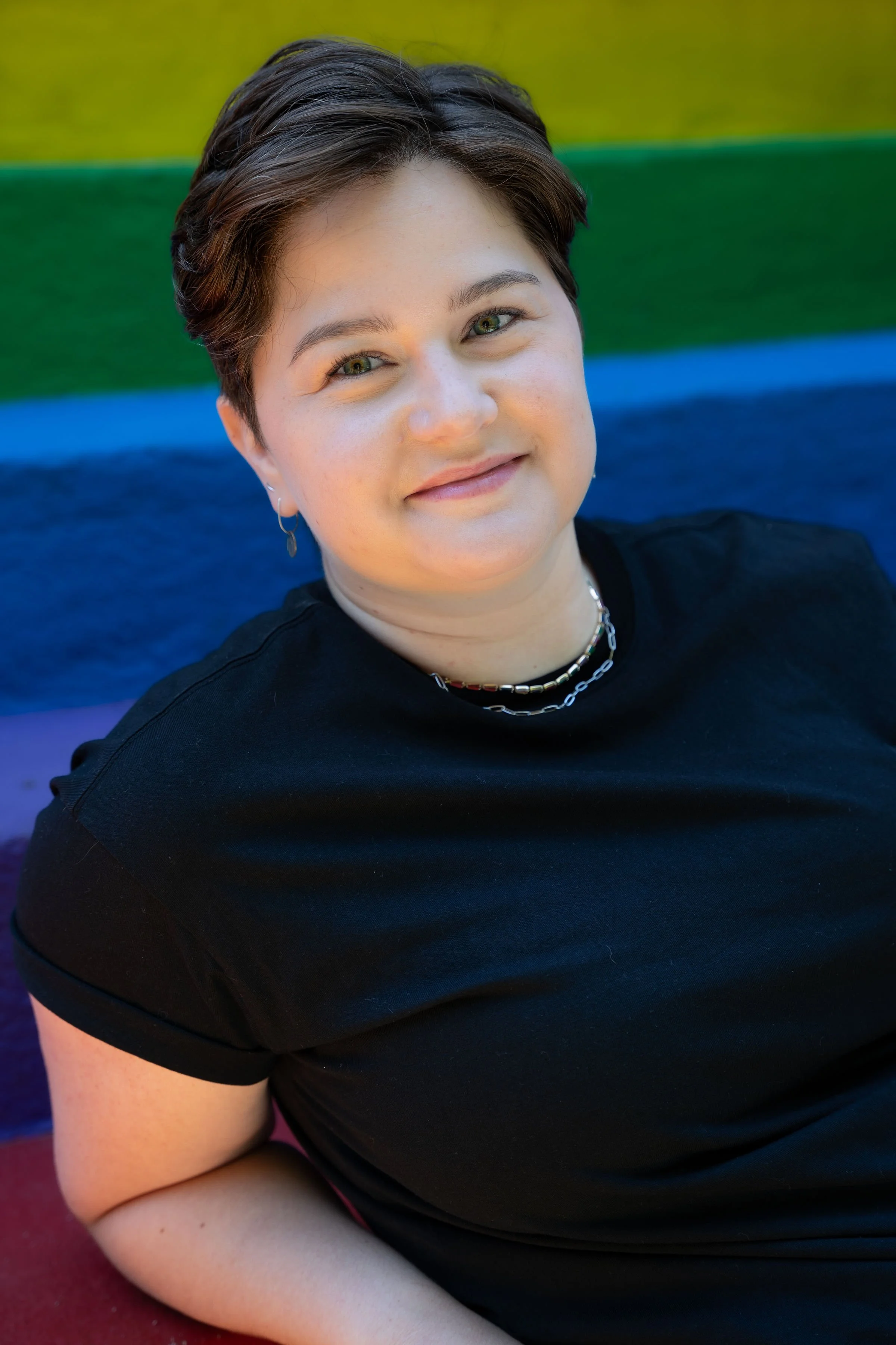 Image of Ally Abrami, a BC therapist/counsellor specializing in virtual appointments for 2SLGBTQIA+, queer, non-monogamy, polyamory, kink, BDSM, hormone readiness assessment, gender affirming care.
