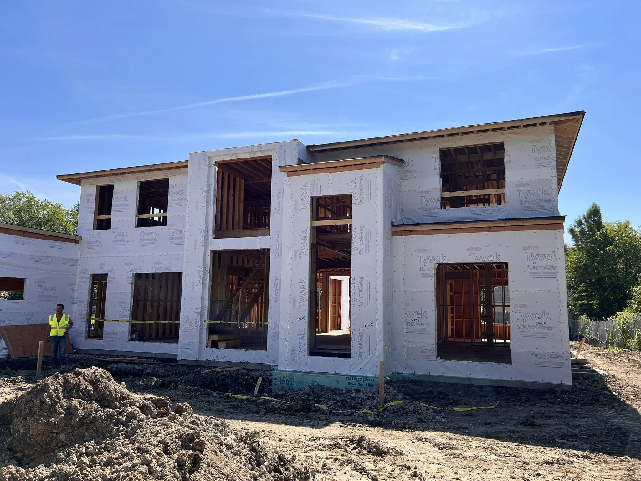 Coorlas Architecture luxury modern home under construction in Glenview, Illinois. The home features tall window openings.