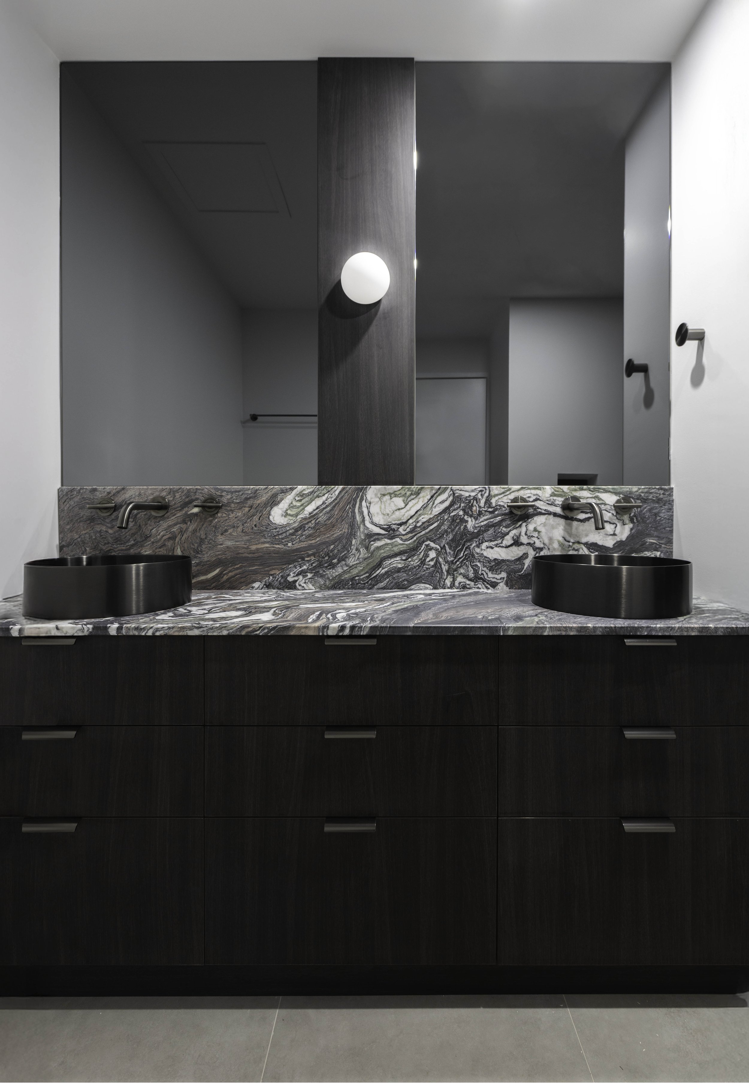 Renovated St Kilda West apartment bathroom with natural stone vanity and calm, spa-like finishes