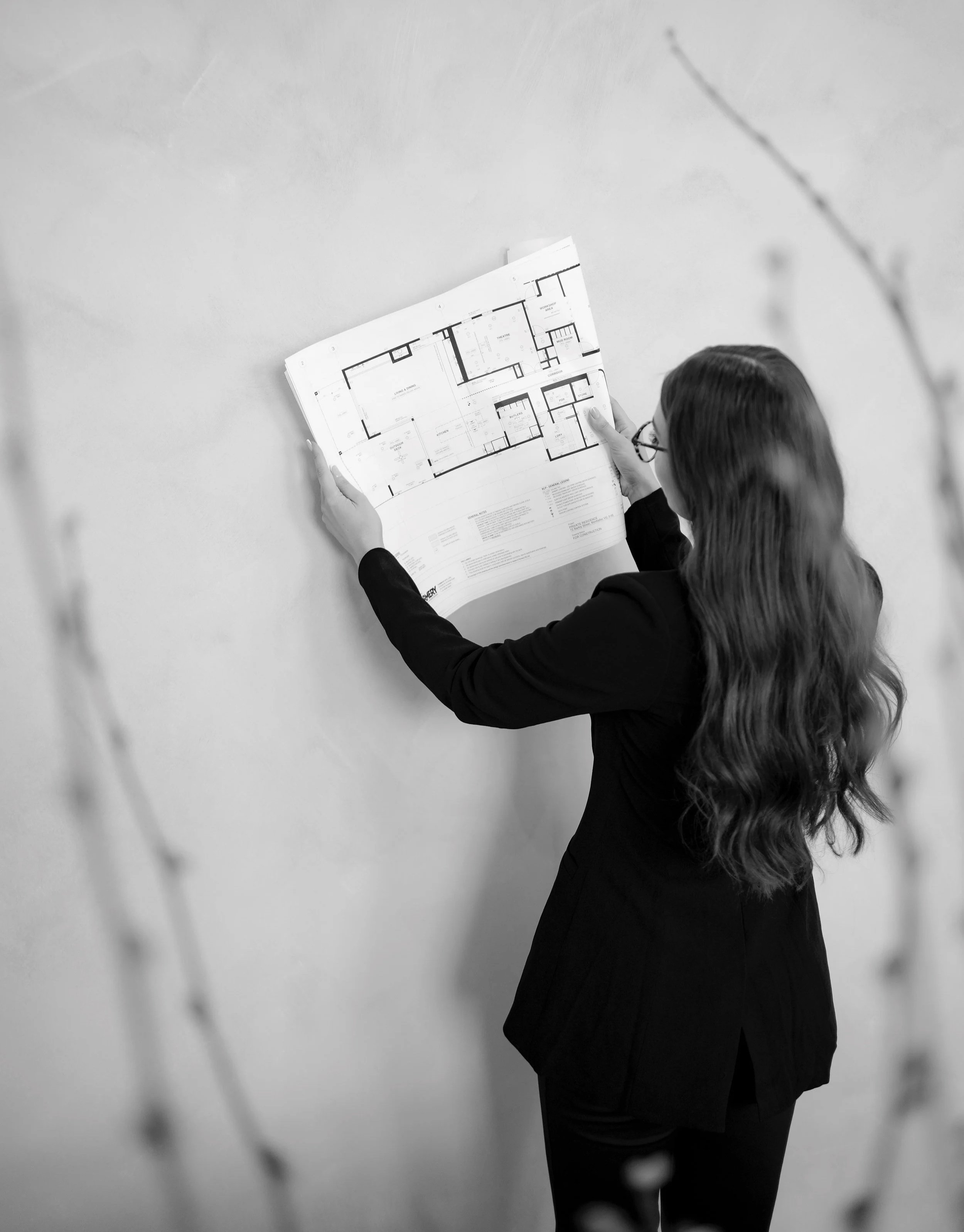 Formery architect reviewing architectural floor plans at the studio