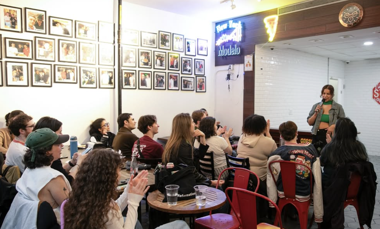 Audience watching Salma Hindy at Nolita Pizza!