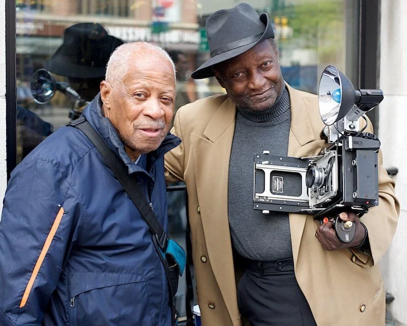 Photography legends - Louis Mendez (r) is a fixture around NYC with his Press Camera. On this day he introduced me to Bob Taylor, another long time photographer. Mr. Mendez told me he bought his press camera in 1959 when he worked at Macy's on 34th S