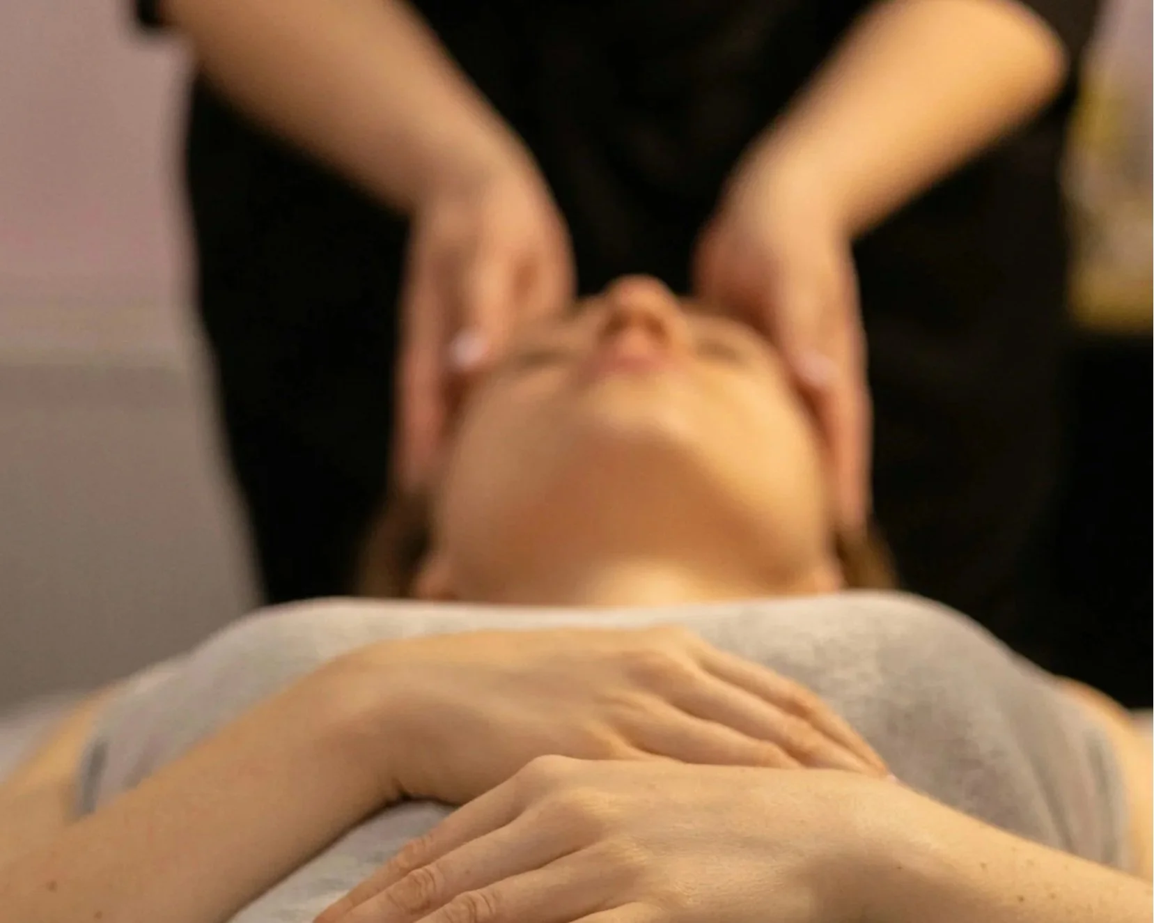A massage therapist providing focused, deep pressure to a client's neck and shoulders during the Essential Express massage at Blue Sky Massage in Winter Park, Colorado.