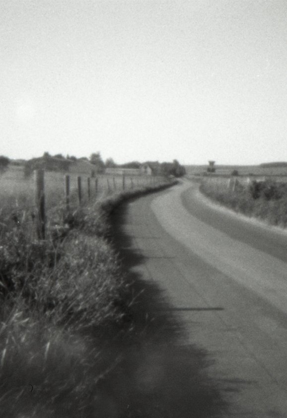 A pinhole photograph of a stretch of road in Wiltshire, UK, curving and stretching off into the distance.