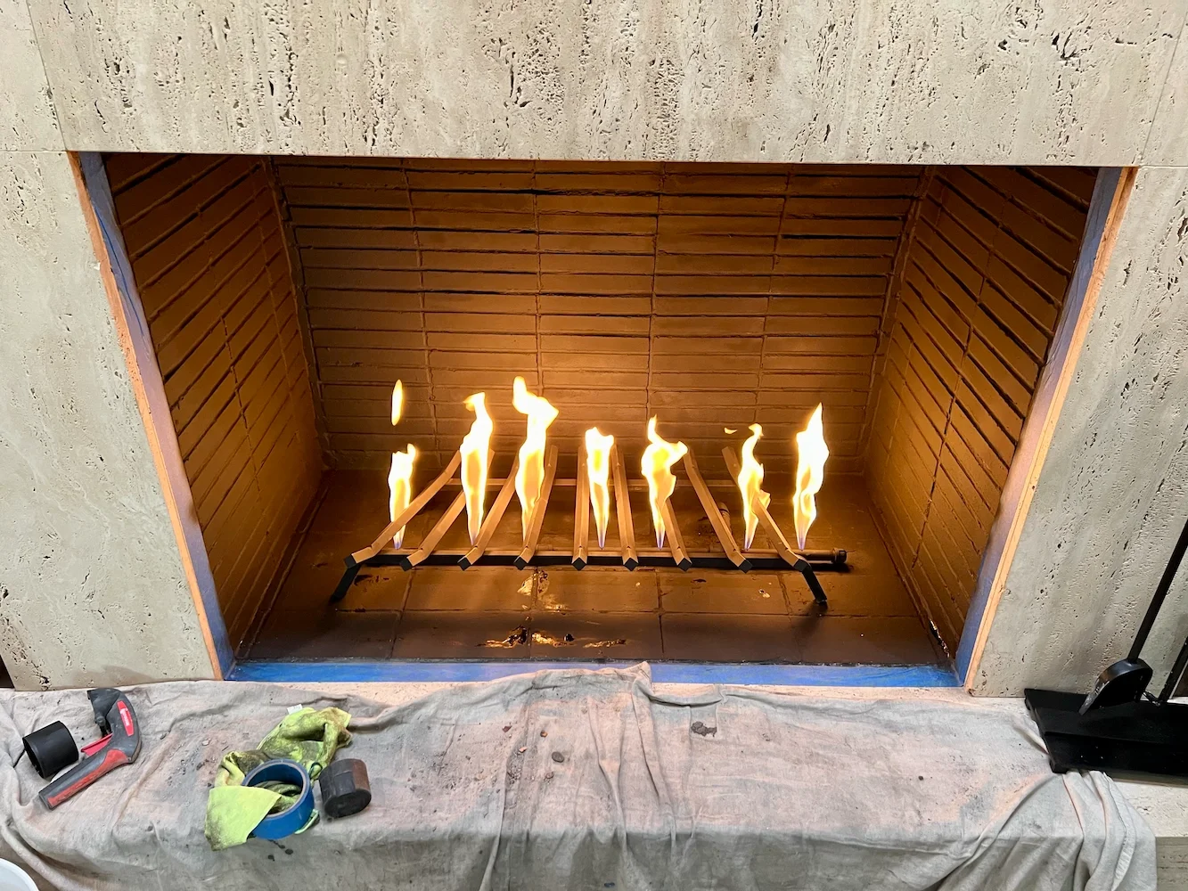 Gas log firebox interior showing active flames inside a North Texas home fireplace
