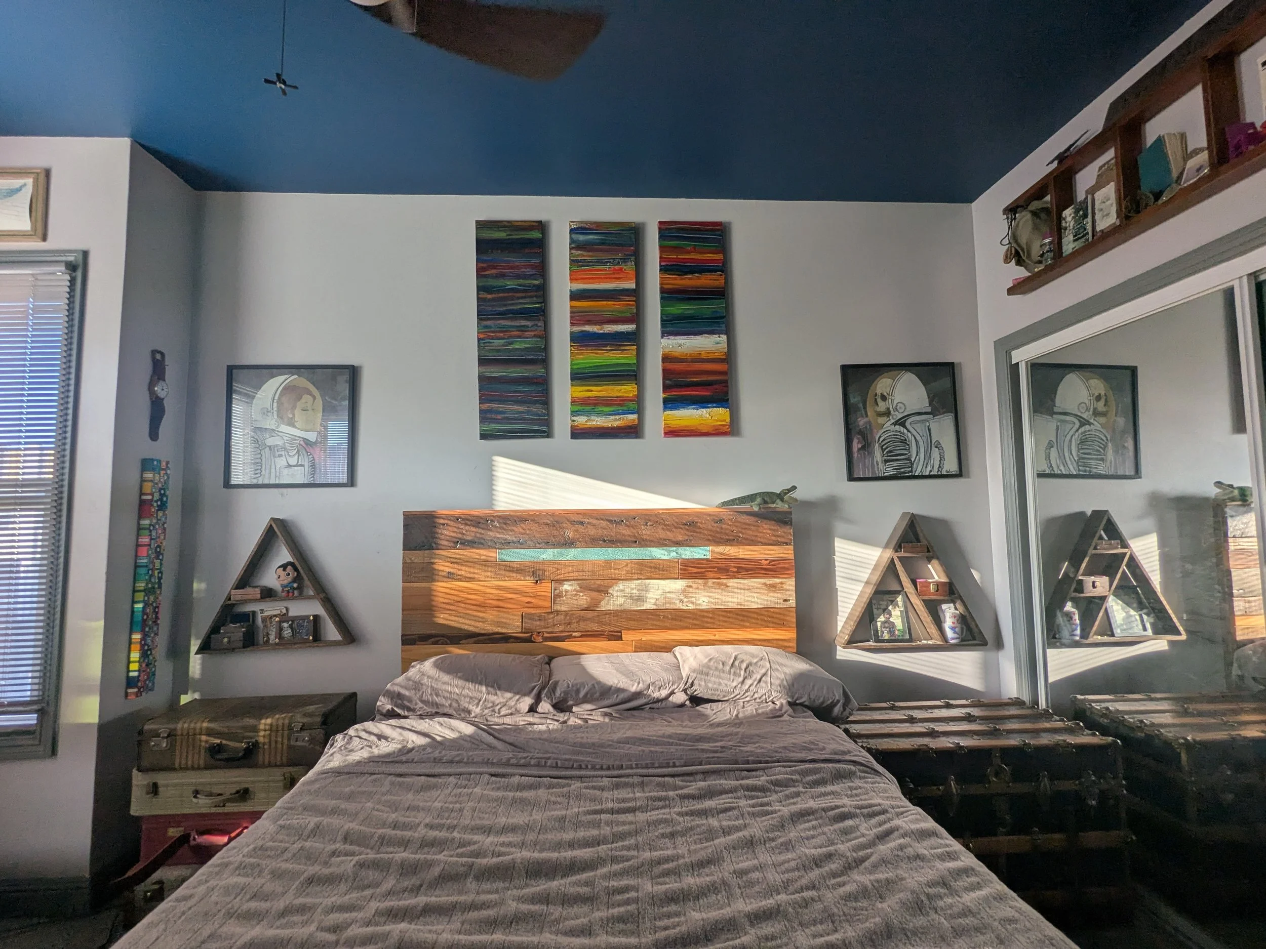 My bedroom. The bed and the shelves are some of the first things I built for myself. Wood I picked up free off of Craigslist.
