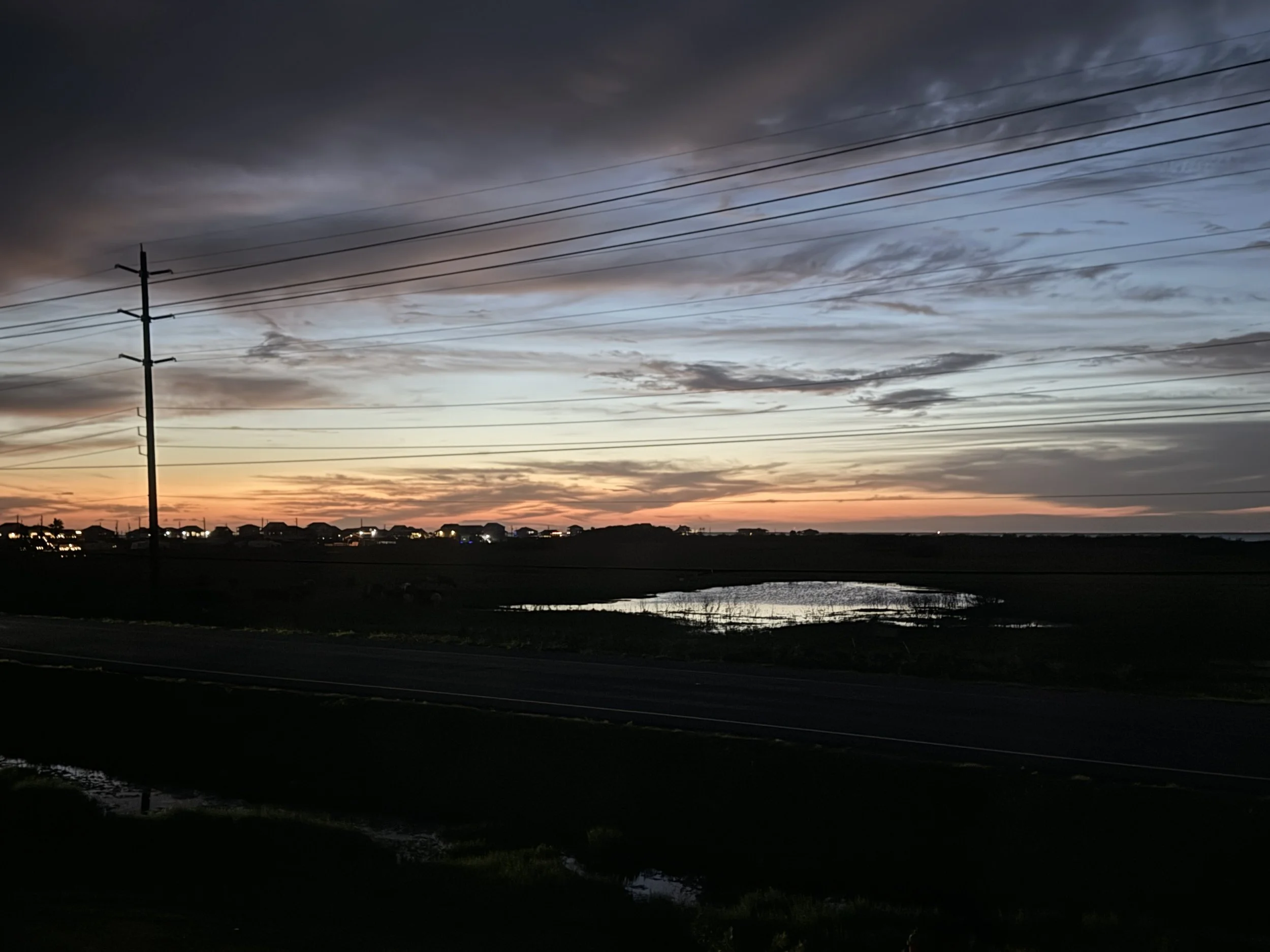 Almost like a porthole - the kitchen window looks out over a farm with the bay in the distance. Gorgeous sunsets await while you're cooking!