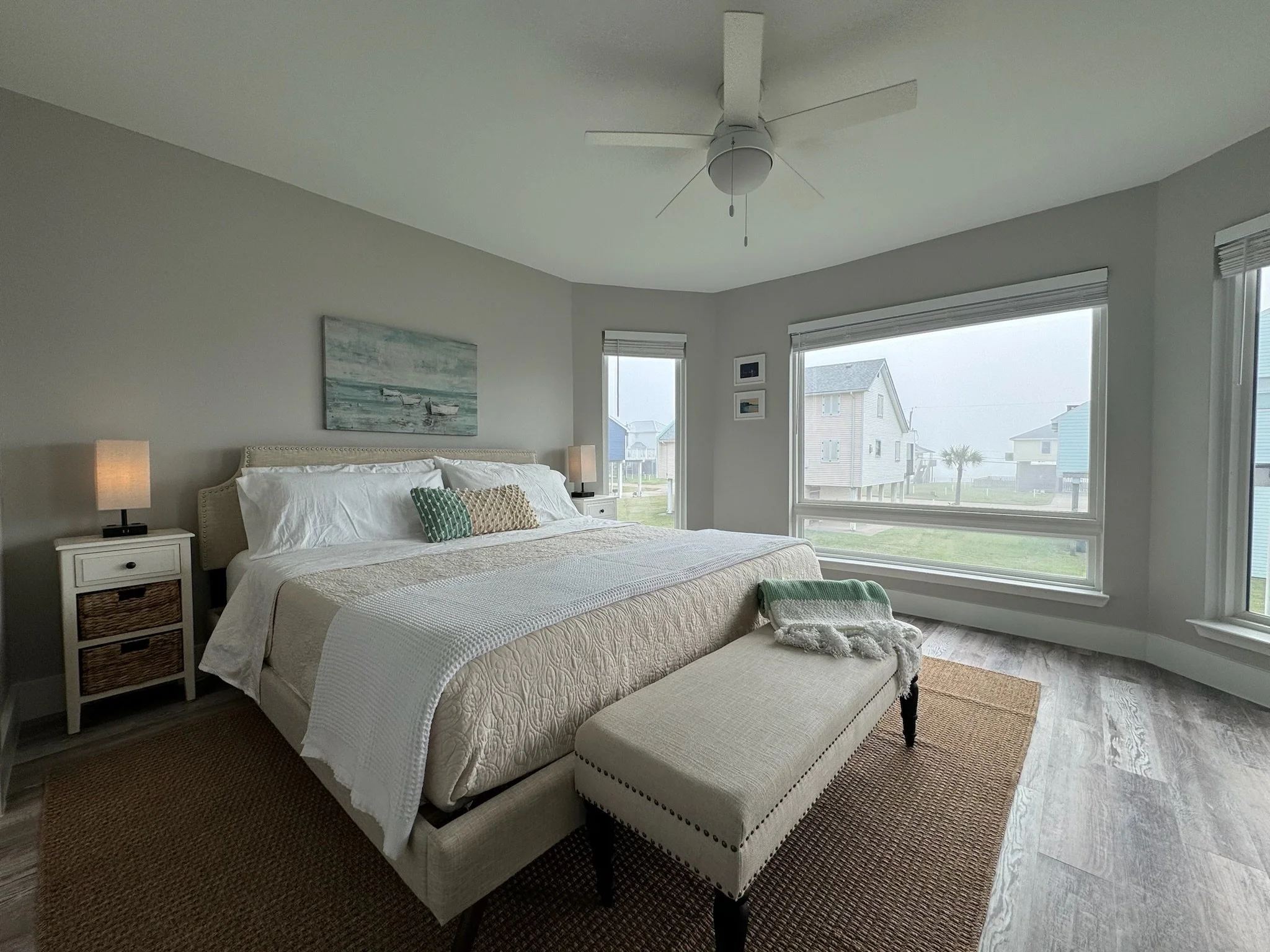 The primary bedroom has a king size bed with memory foam mattress. There is a Roku TV across from the bed on the wall and access to the covered deck outside.