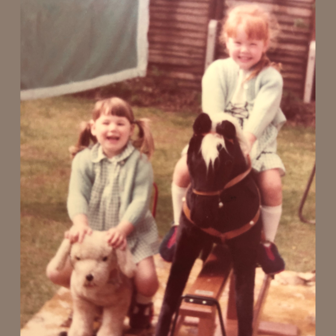 A young Donna sat on a rocking horse in a garden