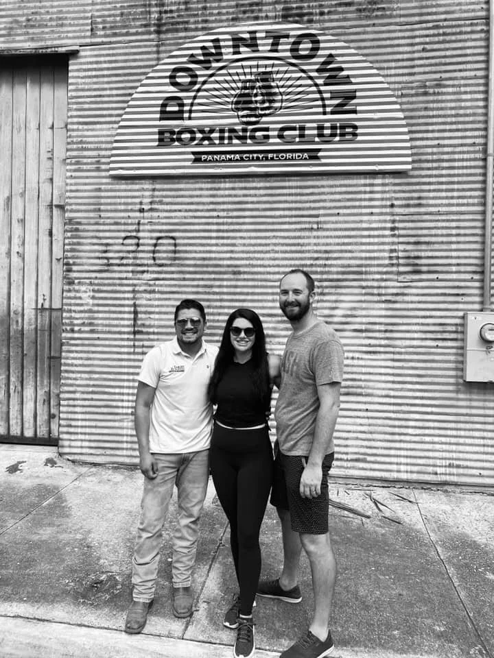 Felix, Jennifer and Chris standing outside of the newly opened Downtown Boxing Club