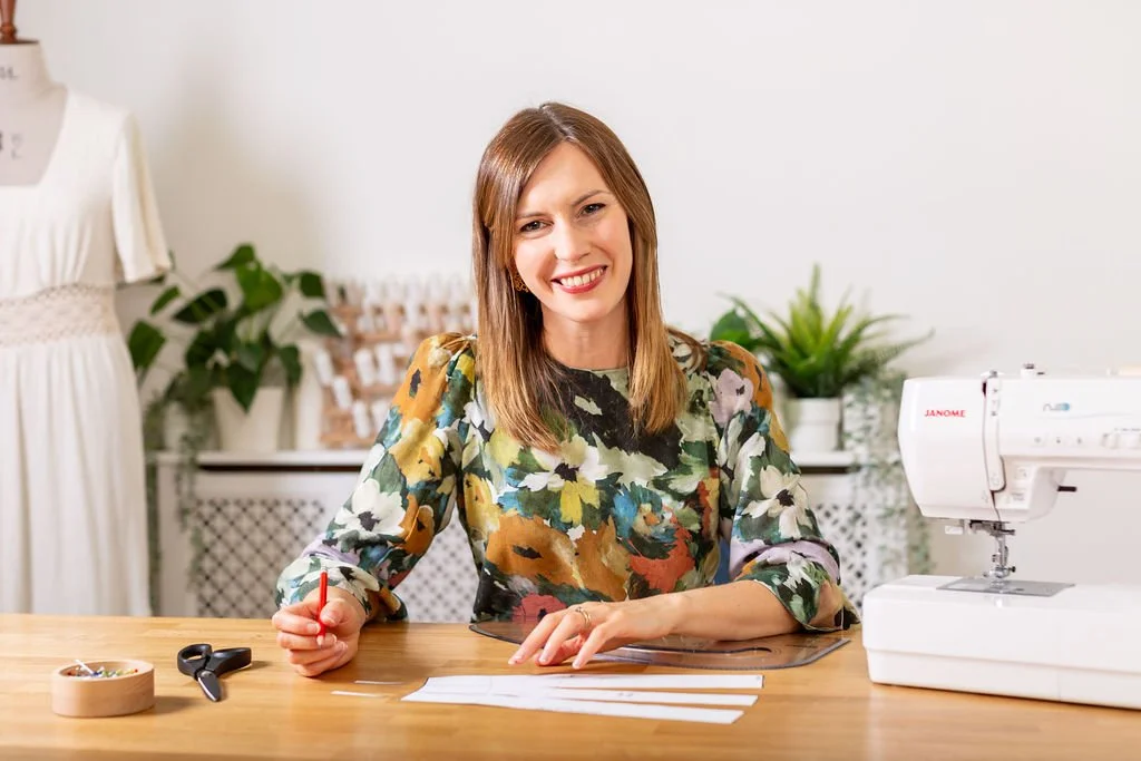 Pattern drafting tutor demonstrating drafting techniques in a sewing studio.