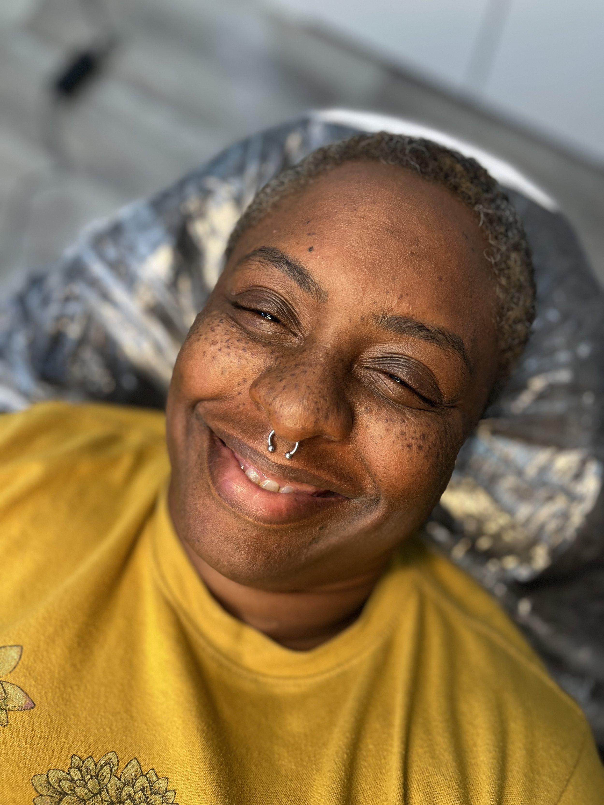 Tattooed Freckles on a darker skinned woman.
