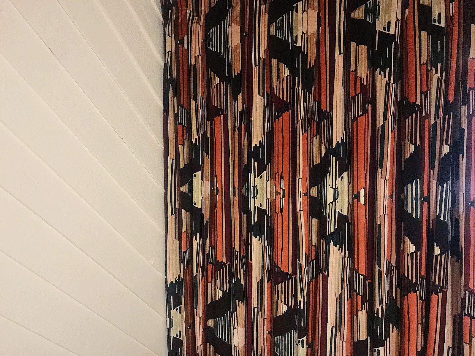 Close up of curtains with red and black designs in the study