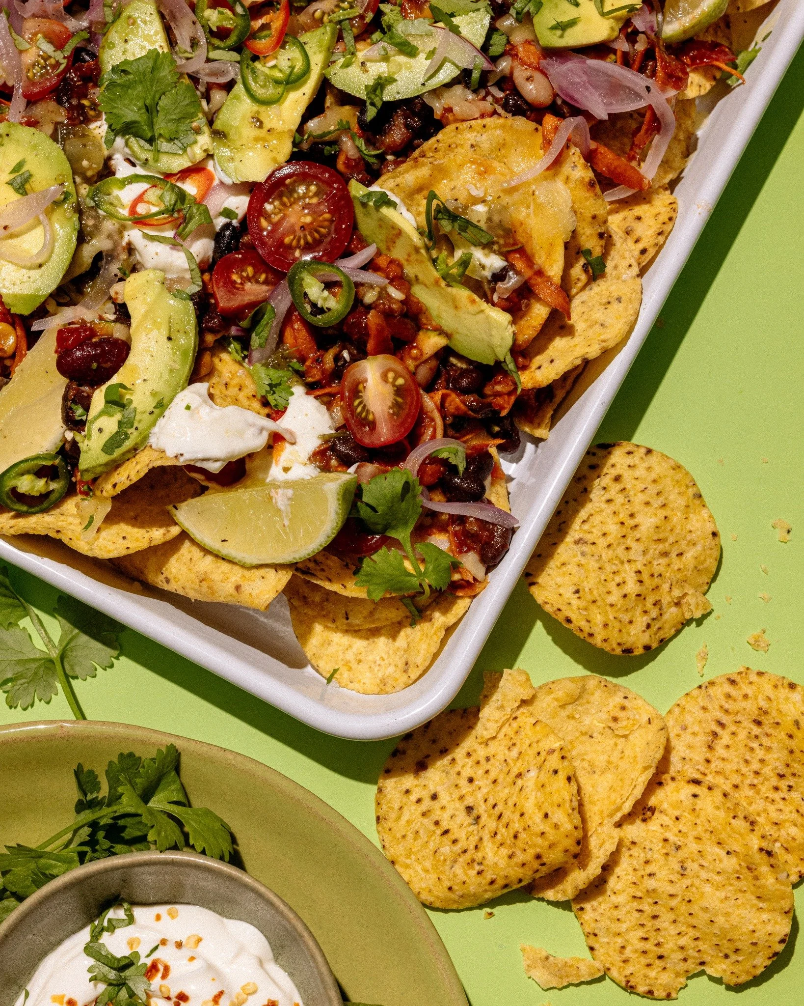 Level up your nachos with this Vege Bean Nacho Tray Bake! 🔥 Layer Mexicano corn chips, vege bean mix and cheese, then bake till golden. Pile on sour cream, avo, cherry tomatoes, pickled onions &amp; a chilli kick. Top with coriander, lime &amp; extr