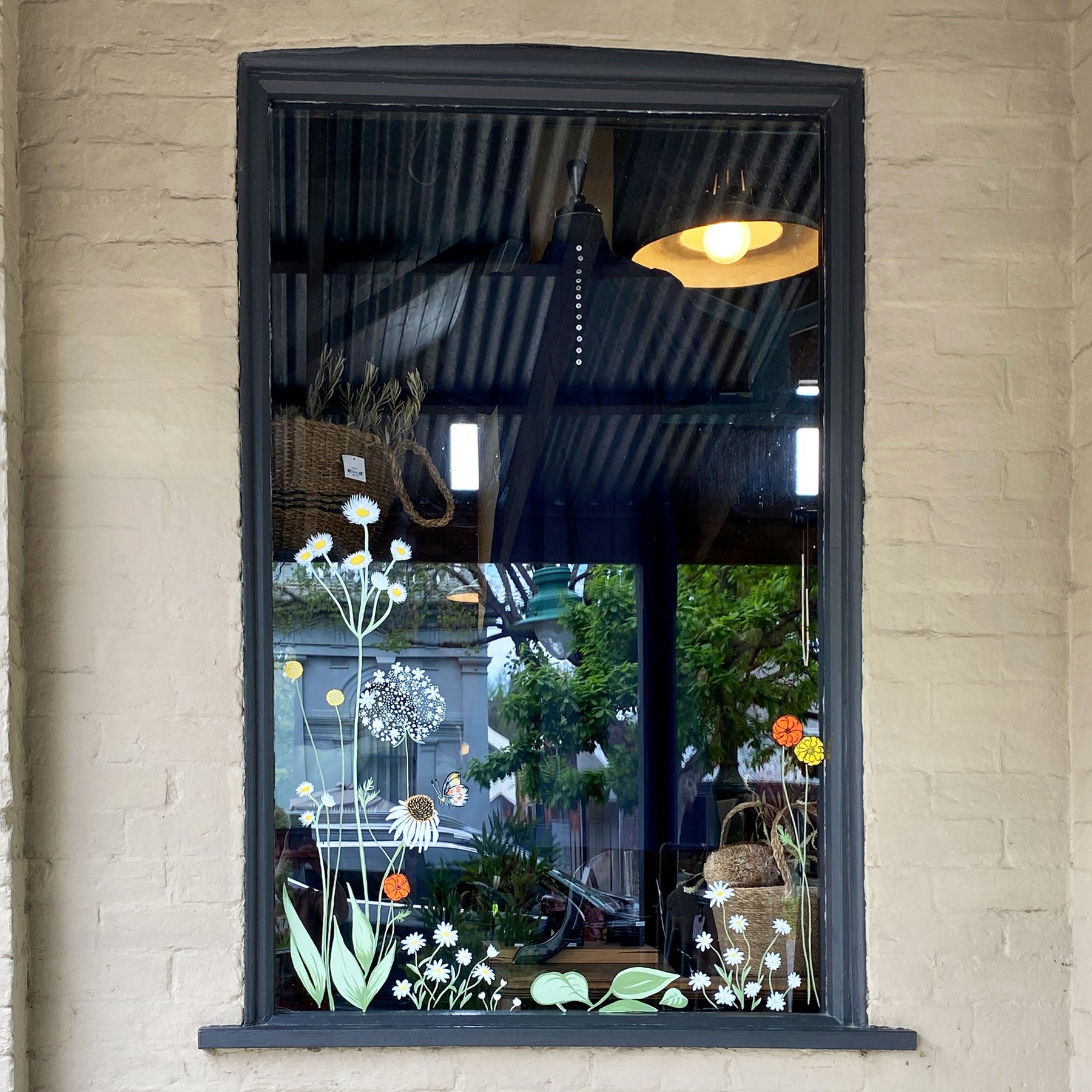 painted spring florals with butterfly on shop window