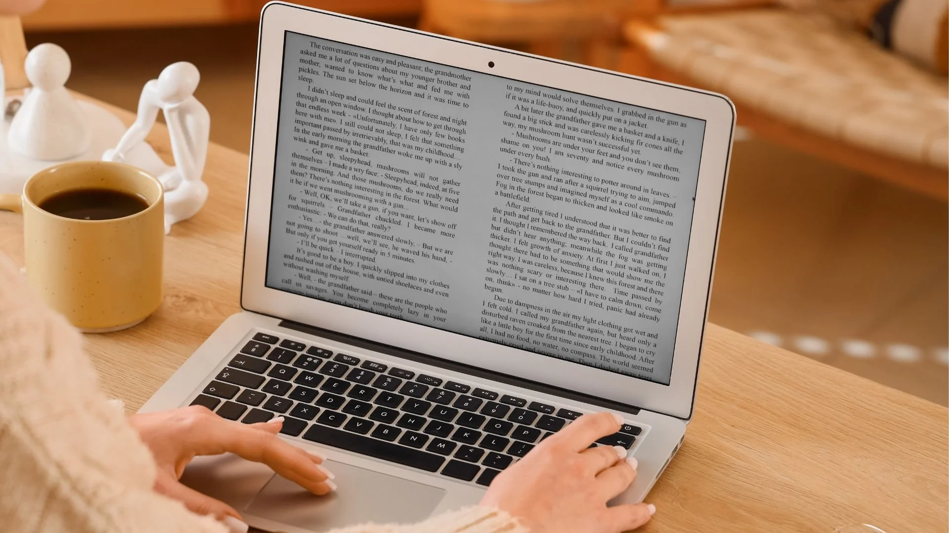 Author reviewing a manuscript on a laptop while self-publishing a book