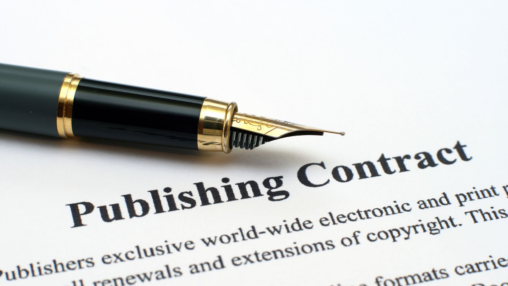 Fountain pen resting on a publishing contract, representing the decision to sign with a self-publishing company in Canada